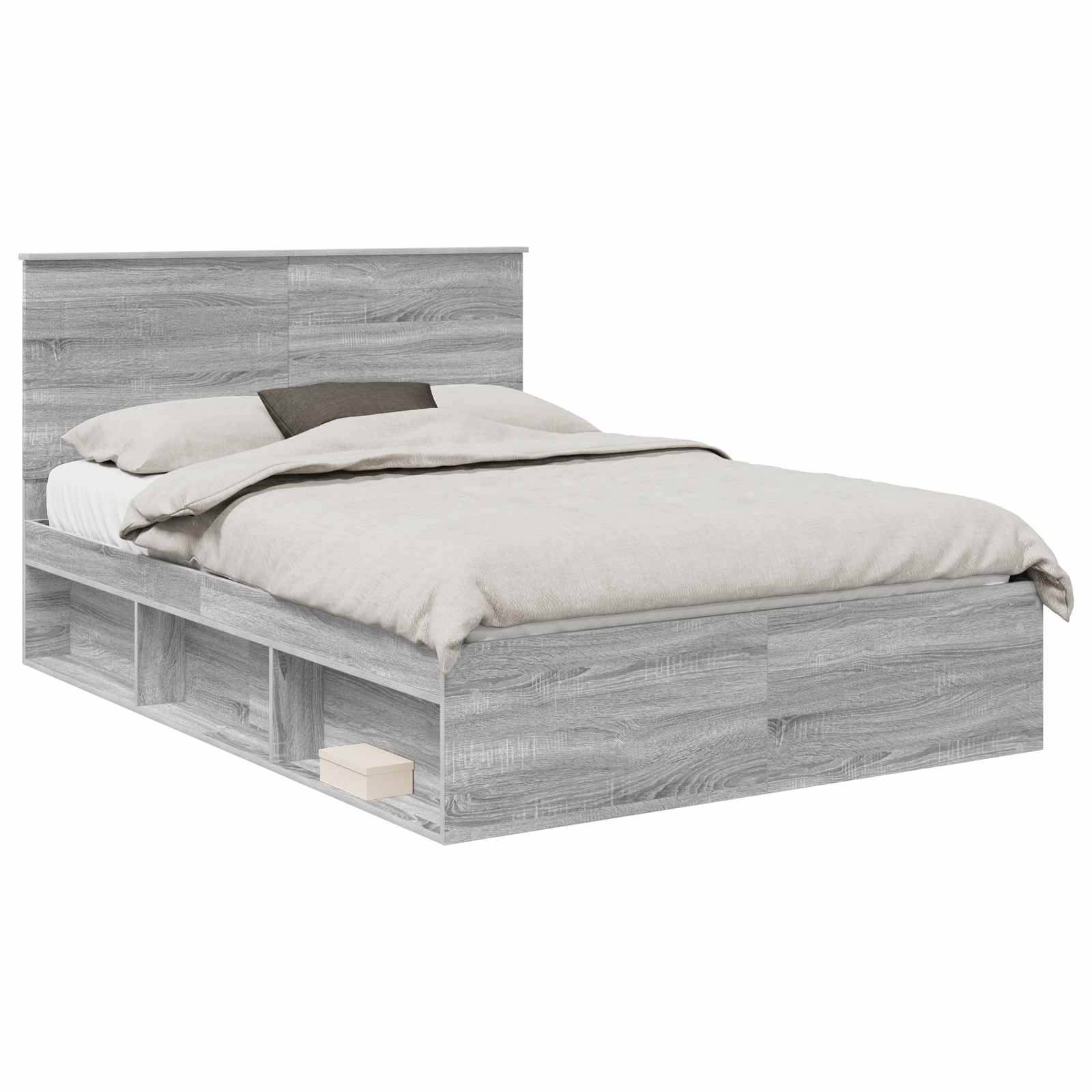 Ein grauer Holzbettrahmen mit Kopfteil, weißer Bettwäsche und zwei Kissen. Das Bett verfügt über integrierte Stauraummöglichkeiten an den Seiten.