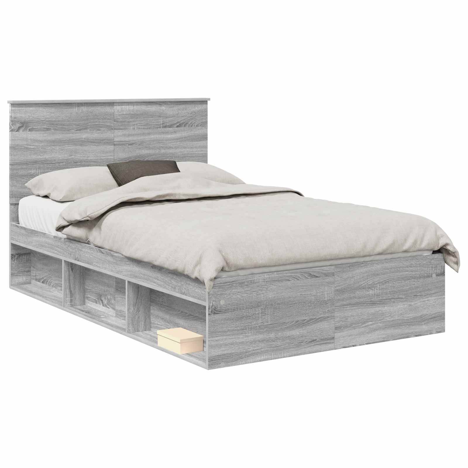 Ein grauer Holzbett mit Stauraumregalen darunter, ausgestattet mit beigefarbener Bettwäsche und einem kleinen beigen Kissen auf einem Holzboden.