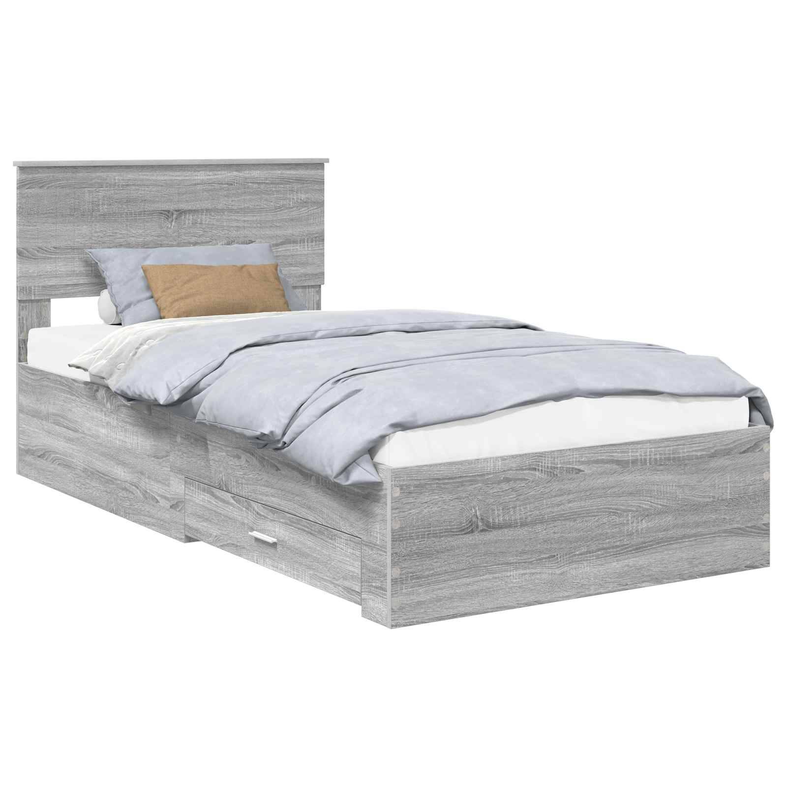 Ein modernes graues Holzbett mit einem Kopfteil, hellblauen Bettwäsche und zwei Schubladen darunter zur Aufbewahrung.