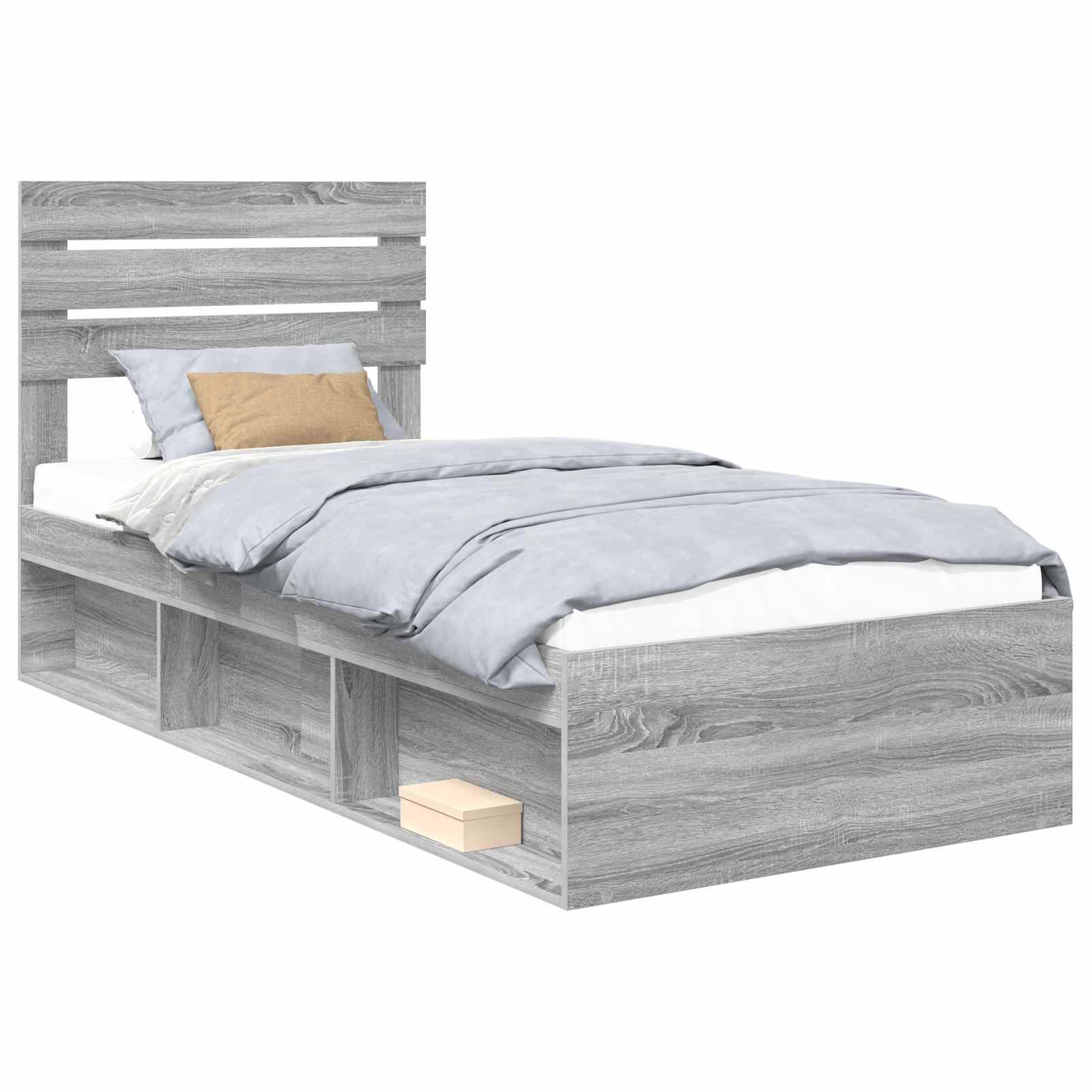 Ein grau lackiertes Holzbett mit Kopfteil, hellblauen Bettwäsche, einem beigen Kissen und Stauraummöglichkeiten unter dem Bett, einschließlich einer kleinen Schublade.