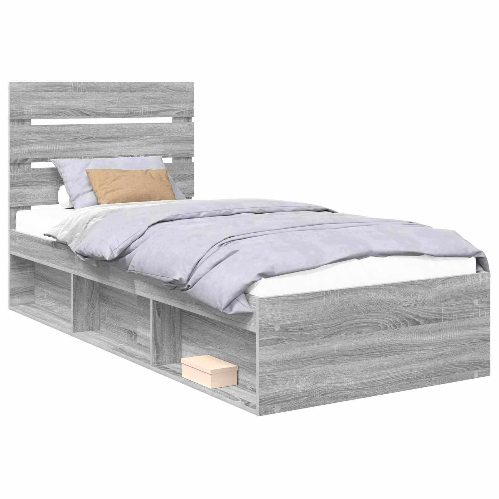 Ein modernes graues Einzelbett mit einer hellblauen Bettdecke und einem beigen Kissen, ausgestattet mit integriertem Regalstauraum darunter.