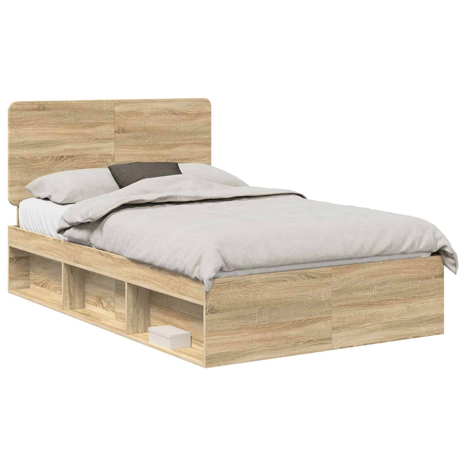 Ein hölzernes Bett mit einem Kopfteil, ordentlich gemacht mit grauer Bettwäsche. Die Basis verfügt über offene Regale zur Aufbewahrung, in denen ein Buch liegt.