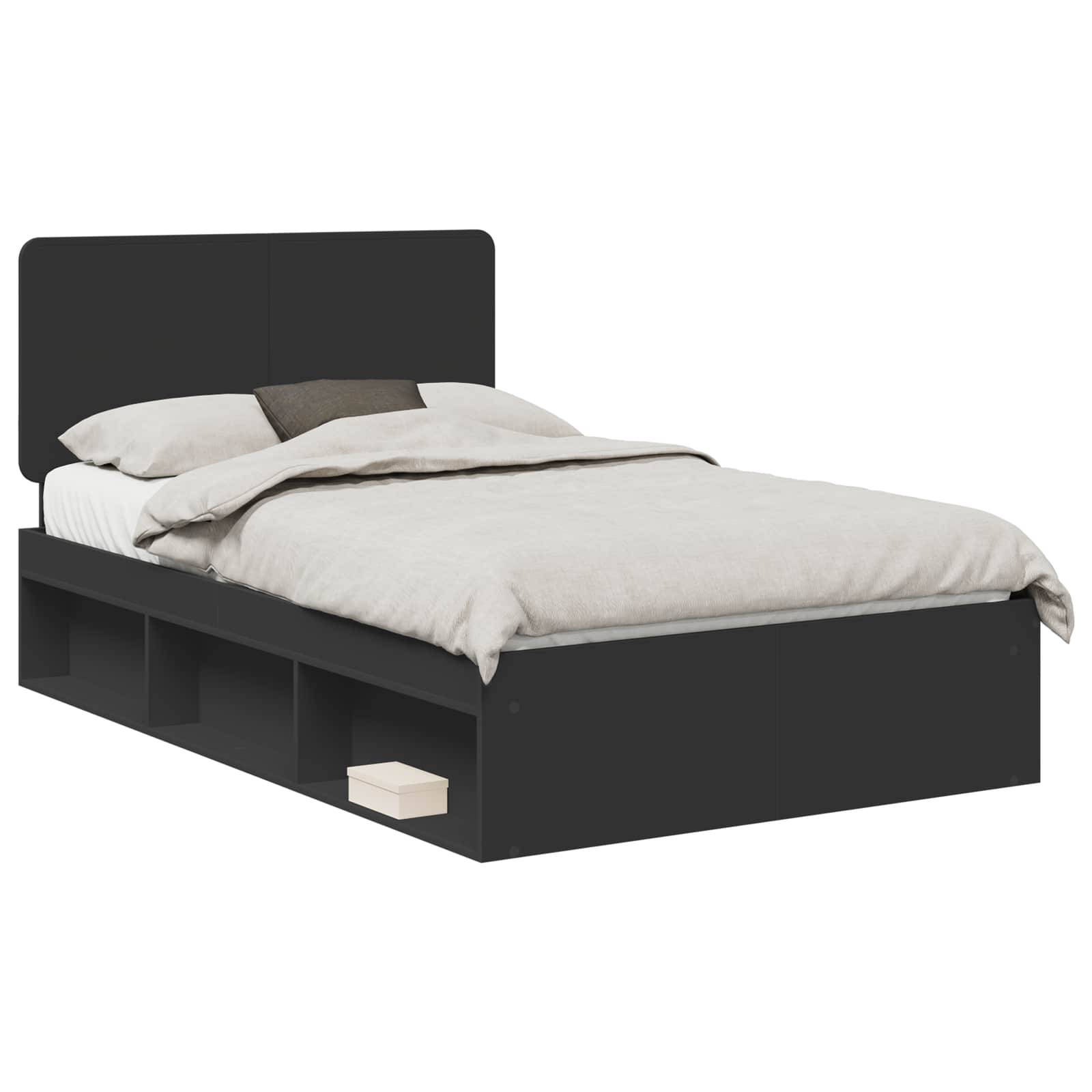Ein schwarzes Einzelbett mit Kopfteil, beigefarbener Bettwäsche und integrierten Stauraumbereichen darunter, diagonal positioniert.