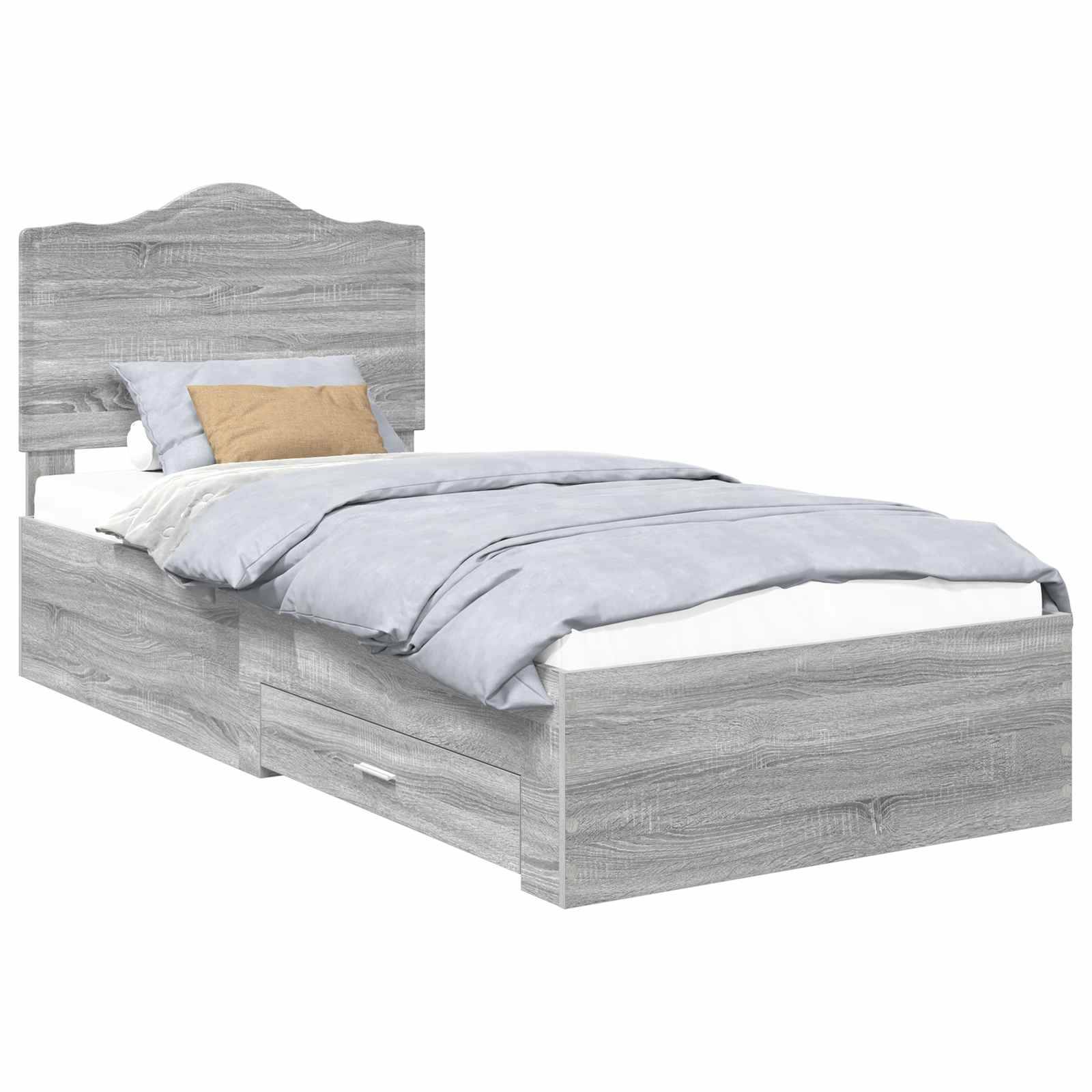 Ein hellgrauer Holzbett mit einem Kopfteil und zwei Schubladen darunter. Das Bett ist mit blau-weißer Bettwäsche und einem braunen Kissen bezogen.