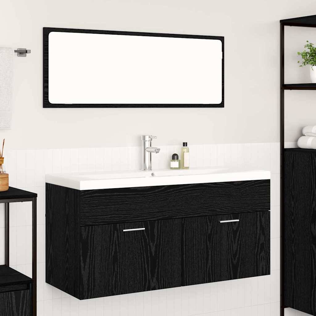 Ein modernes Badezimmer zeigt eine schwarze Holzwaschtisch mit einem großen rechteckigen Spiegel darüber, einem silbernen Wasserhahn und einer kleinen Pflanze in der Nähe.