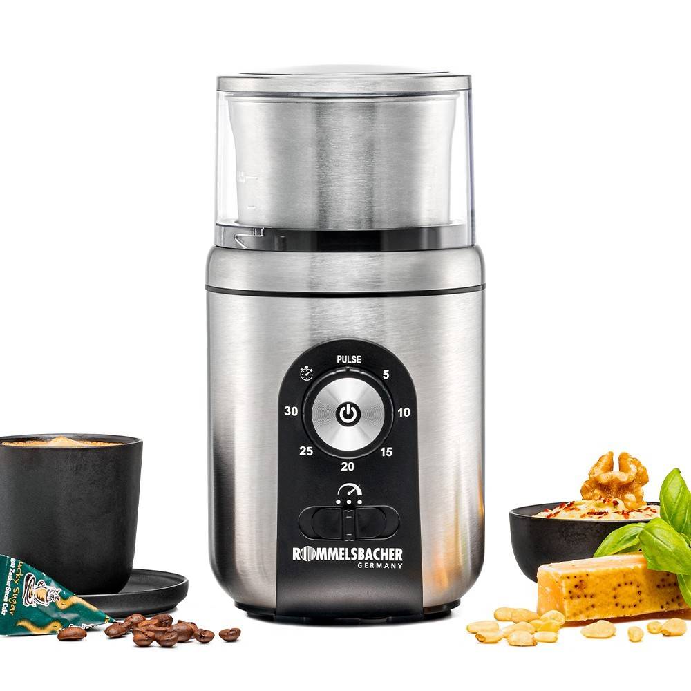 Kaffeemühle umgeben von einer Tasse Kaffee, Schokolade, Kakaobohnen und Gewürzen, was ihre Verwendung zum Mahlen von Zutaten andeutet.