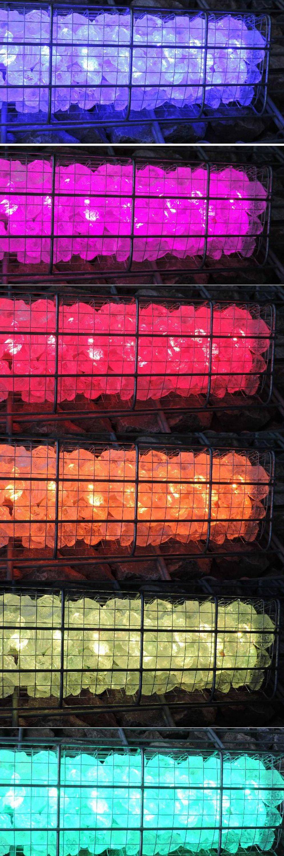 Zwei industrielle Heizgeräte mit glühenden Steinen, eines über dem anderen. Das obere leuchtet rot, das untere orange, vor einem Ziegelwandhintergrund.