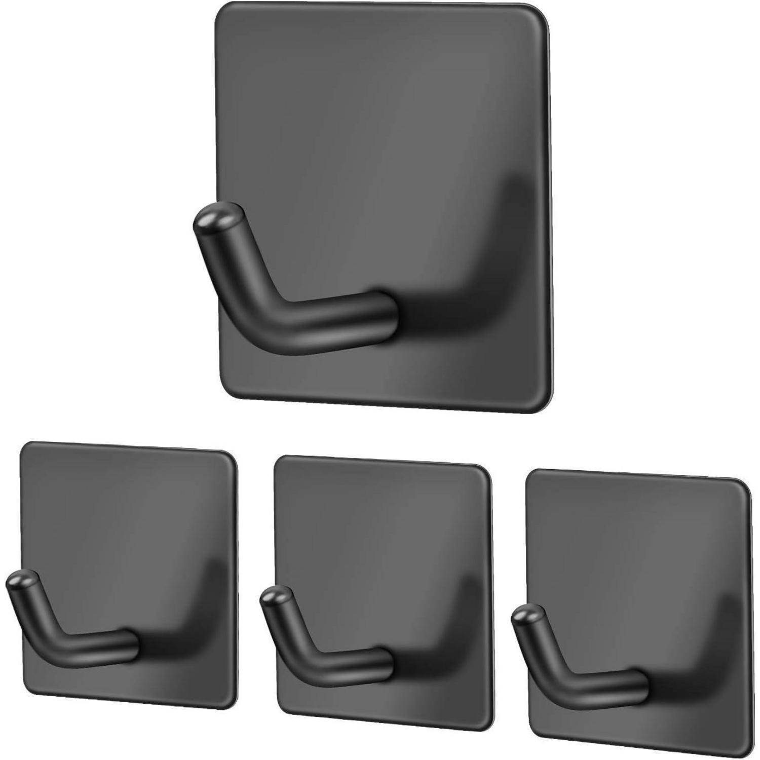 Ein Set aus vier schwarzen Klebehaken, jeder mit einer quadratischen Basis und abgerundeter Hakenbügel, auf einem einfarbigen Hintergrund gezeigt, zum Aufhängen von Gegenständen.