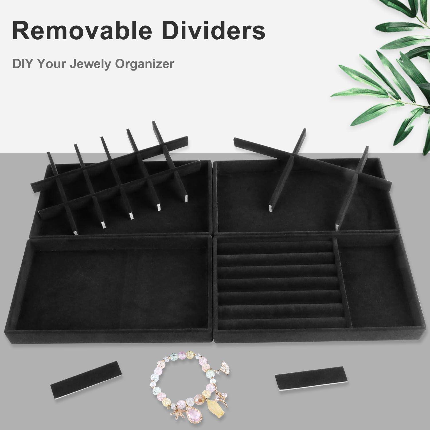 Schwarzer Schmuckorganizer mit herausnehmbaren Trennwänden, der Bereiche für Ringe und Armbänder aufweist. Ein pastellfarbenes Armband wird davor präsentiert.