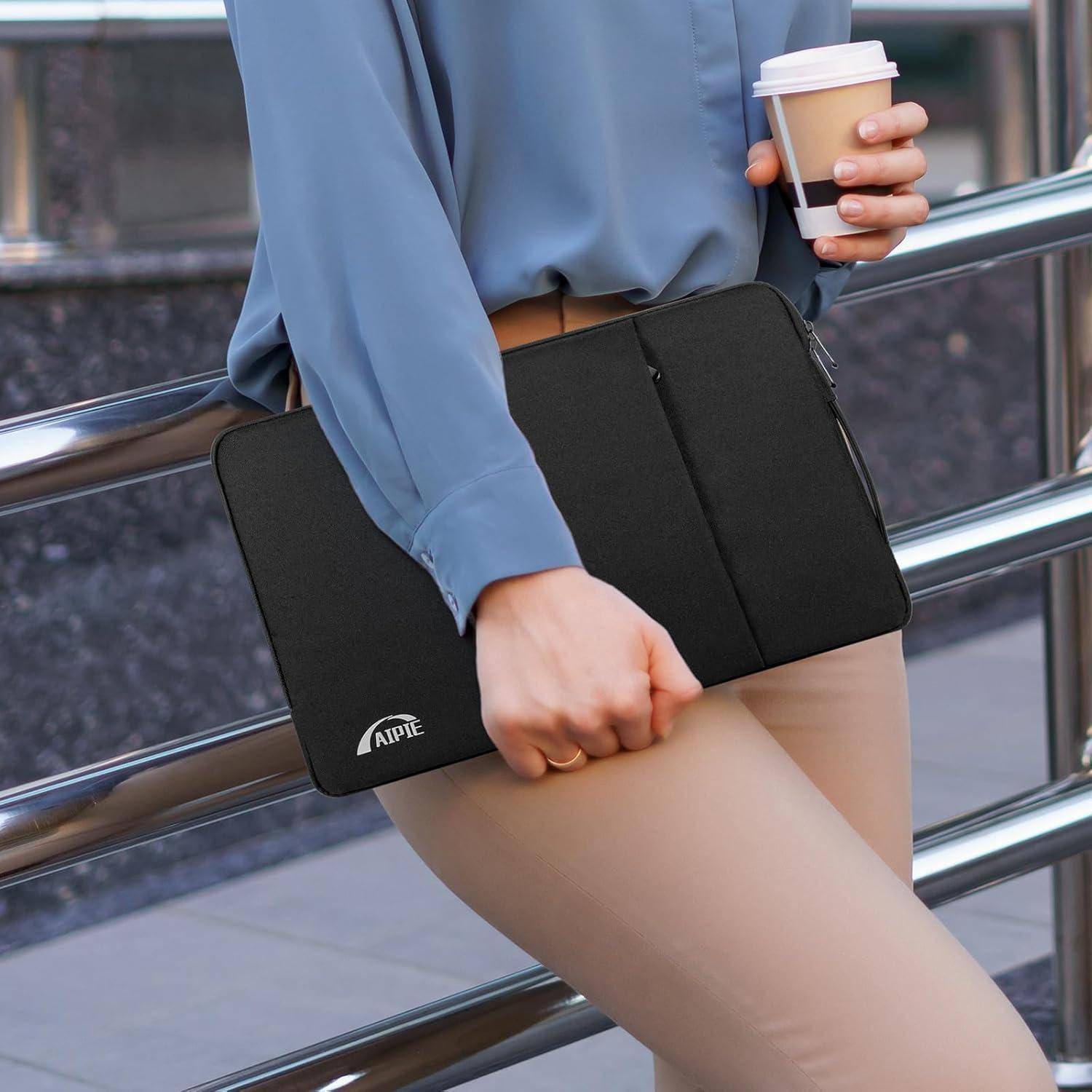 Eine Person in einem blauen Hemd hält eine schwarze Mappe und eine Kaffeetasse, während sie sich an einem Geländer im Freien lehnt.