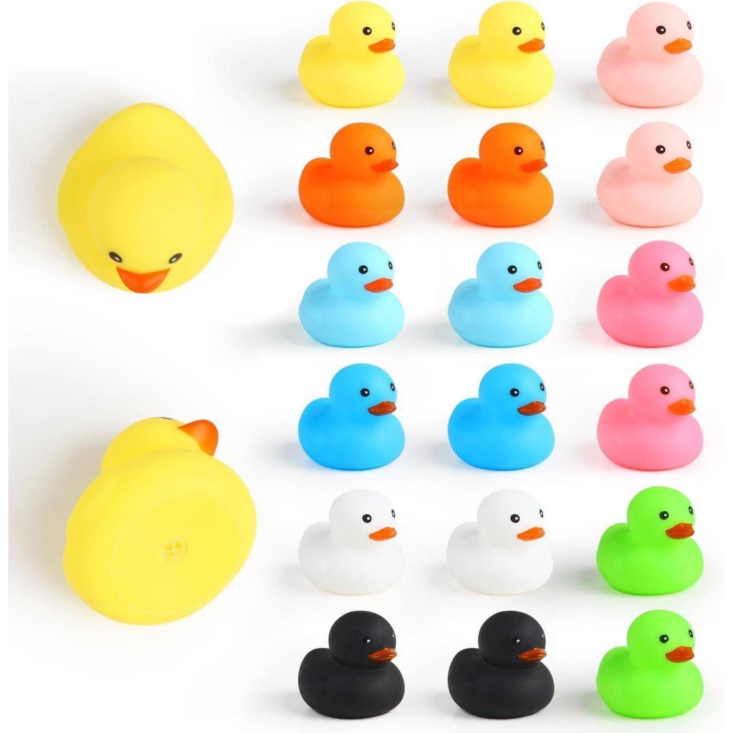 Reihe von Gummientchen in verschiedenen Farben, darunter gelb, orange, blau, rosa, schwarz, grün und weiß, in Reihen angeordnet.