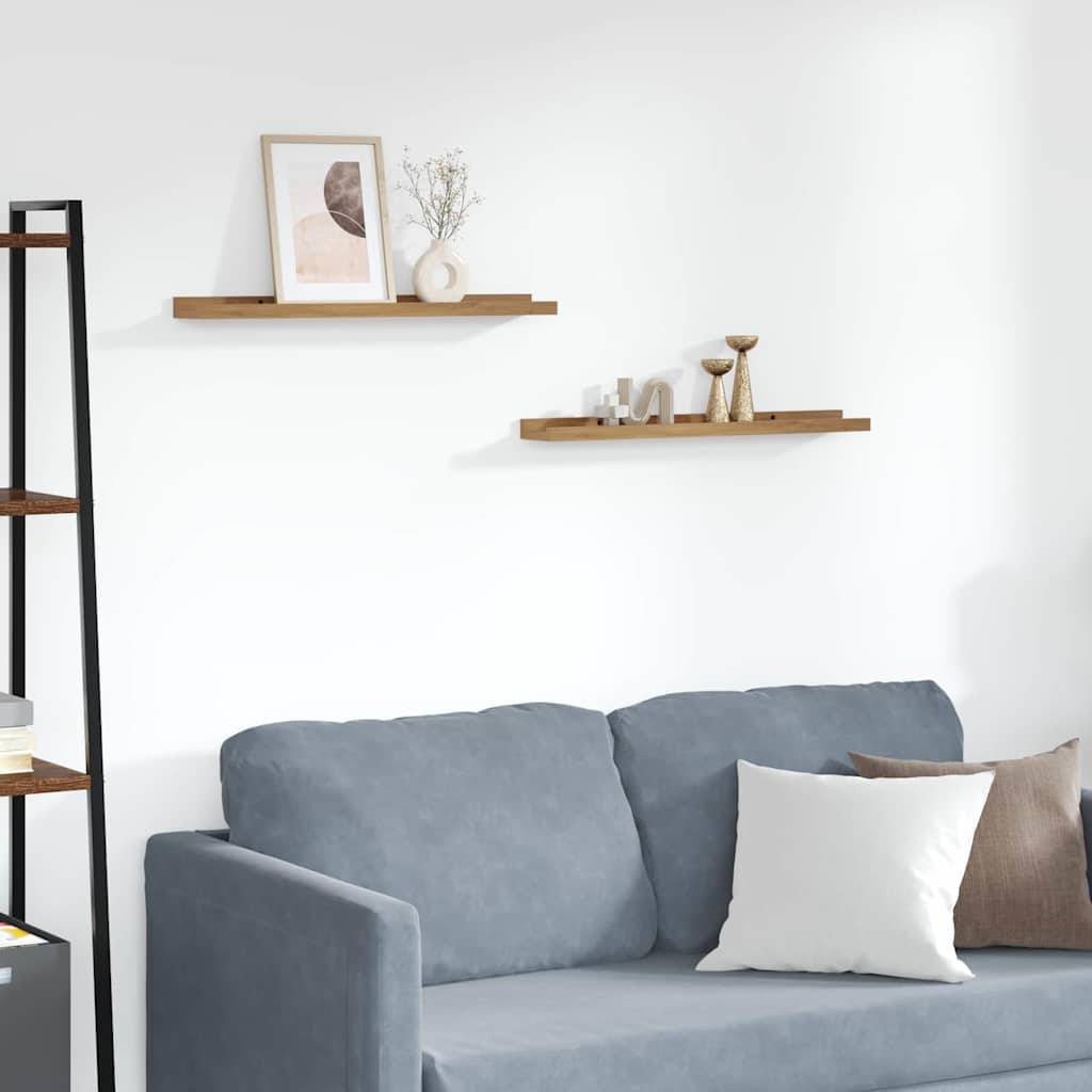 Ein Wohnzimmer präsentiert ein blaues Sofa mit einem weißen Kissen, Wandregale mit Dekorationselementen und eine minimalistische Ästhetik.