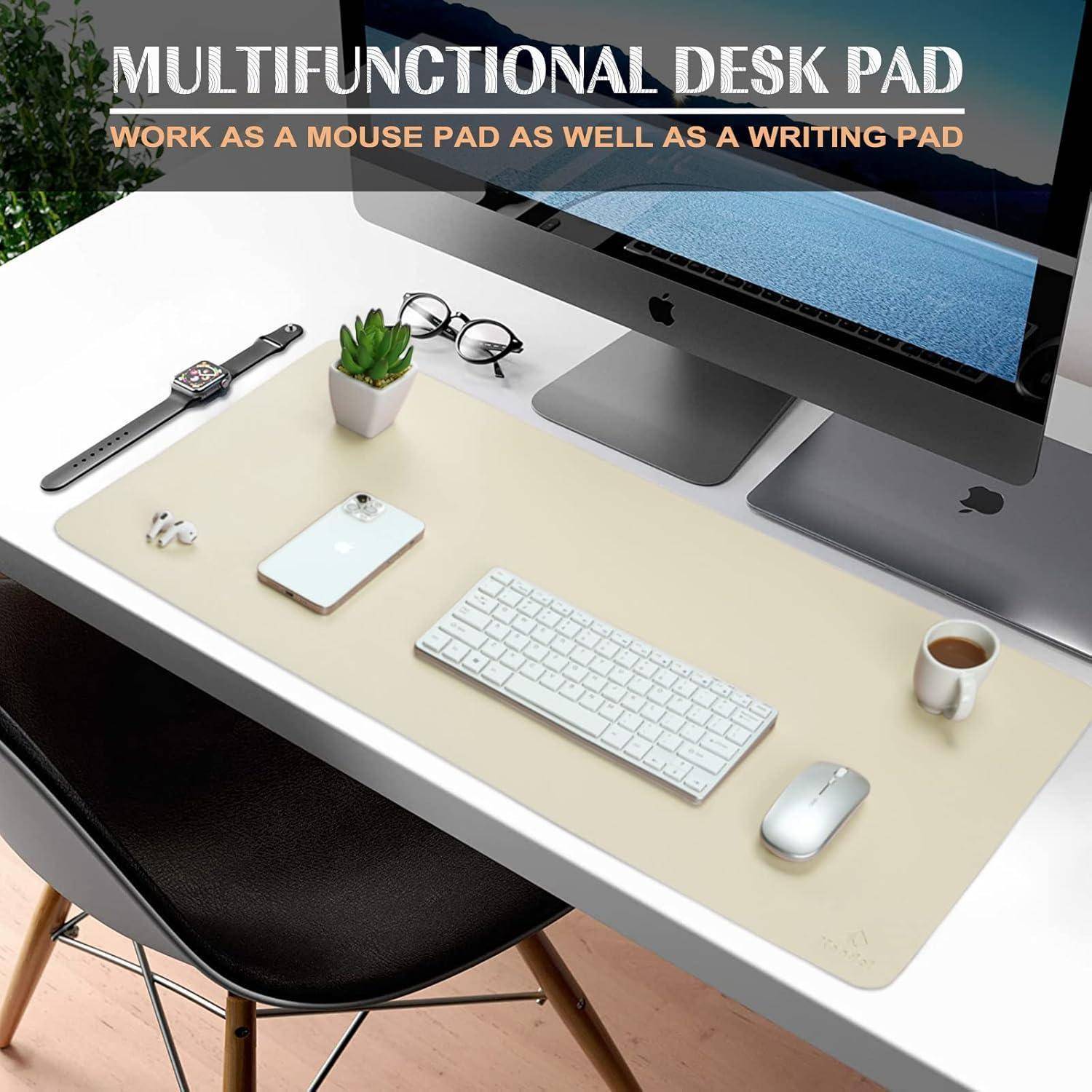 Eine beige Multifunktions-Schreibunterlage auf einem weißen Schreibtisch trägt eine Tastatur, eine Maus, ein Smartphone, einen Stift, ein Notizbuch, eine Brille und eine Pflanze.