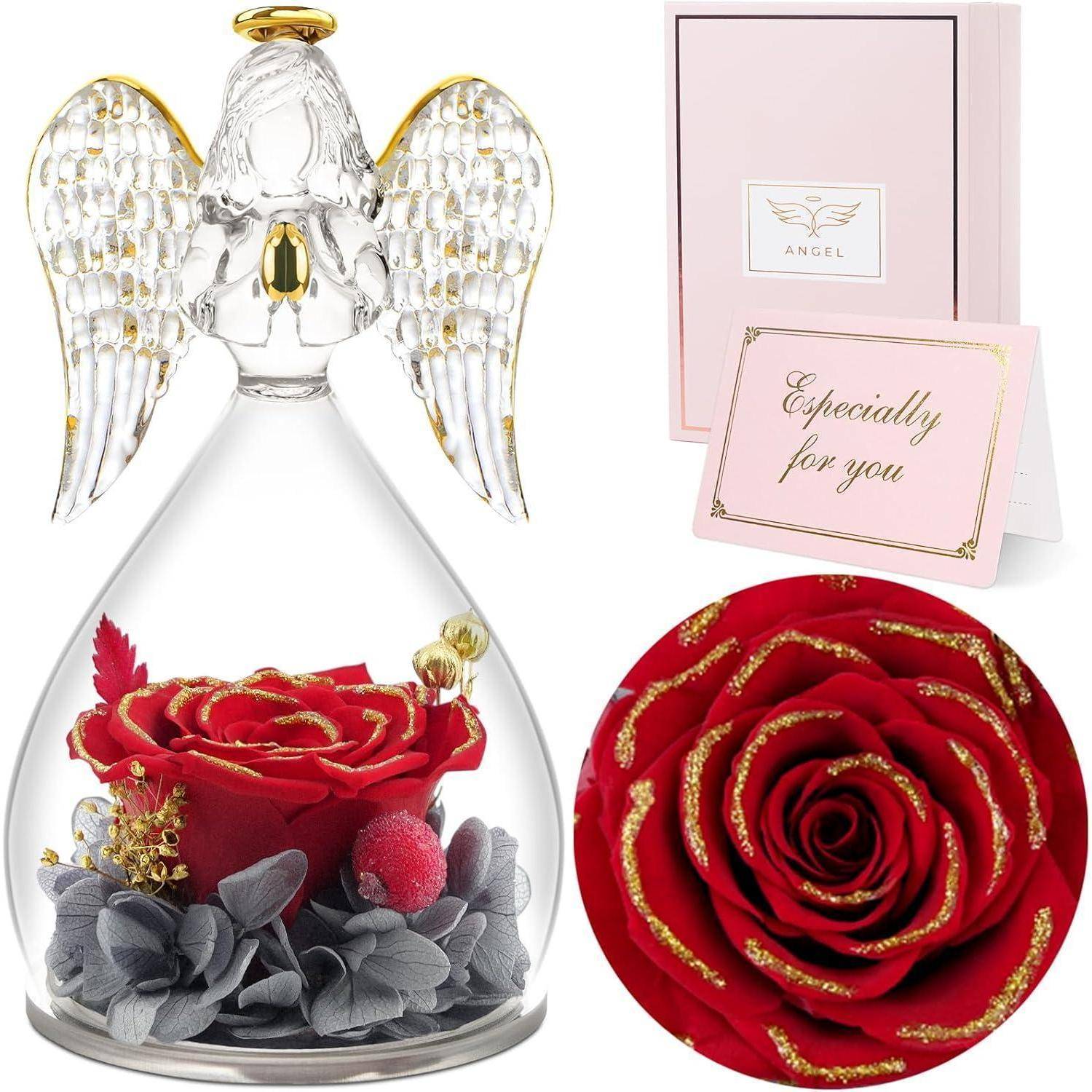 Eine Glasengelfigur mit goldenen Akzenten umschließt eine rote Rose und graue Blumen. Begleitet von einer rosa Geschenkbox und einer Karte mit der Aufschrift „Besonders für dich