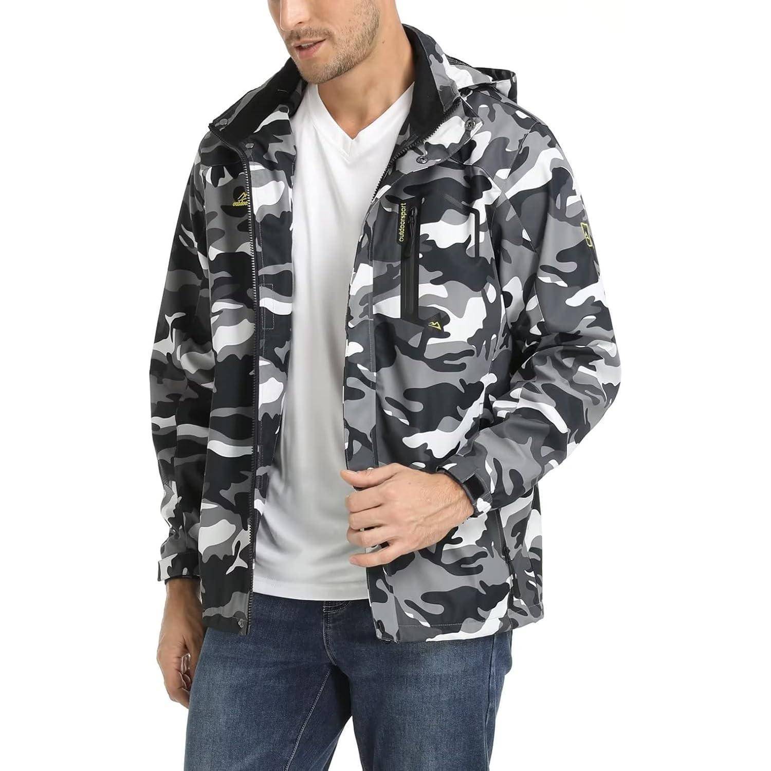 Eine Person, die eine graue Tarnmusterjacke und blaue Jeans trägt, steht in einer entspannten Pose.