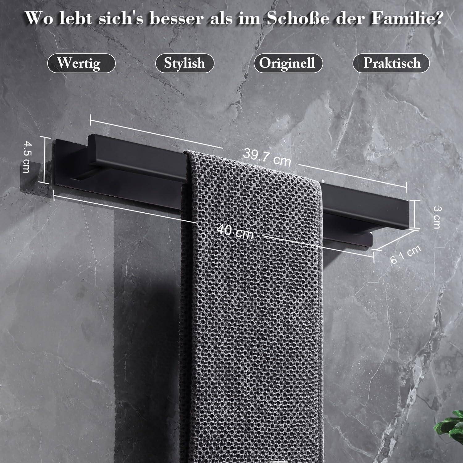 Handtuchhalter mit grauem Handtuch vor einer Steinwand. Abmessungen sind 39,7 cm Breite, 4,5 cm Höhe. Deutscher Text deutet auf Familienleben hin.
