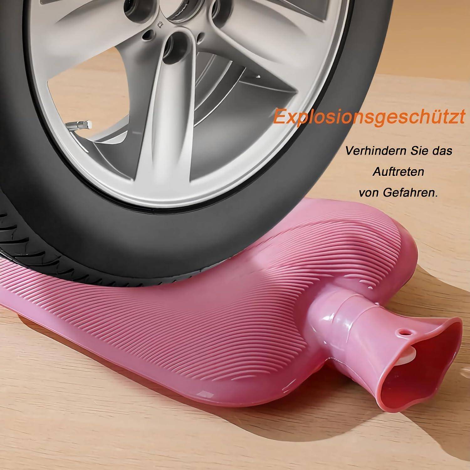 Ein Autoreifen wird auf eine rosa Wärmflasche gelegt, mit dem Text 