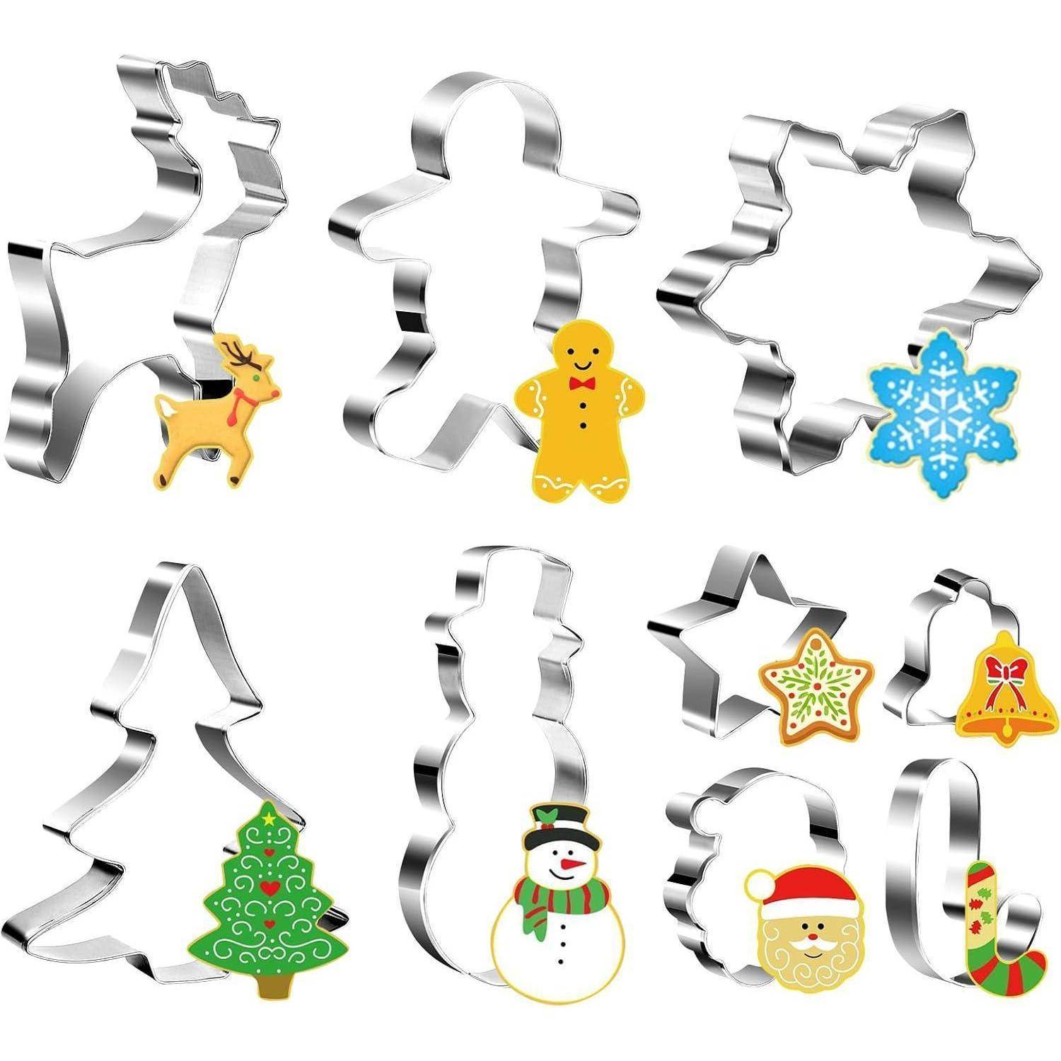 Verschiedene weihnachtlich gestaltete Ausstechformen und verzierte Kekse, darunter ein Rentier, eine Lebkuchenfigur, eine Schneeflocke, ein Baum, ein Schneemann, ein Stern und der Weihnachtsmann.