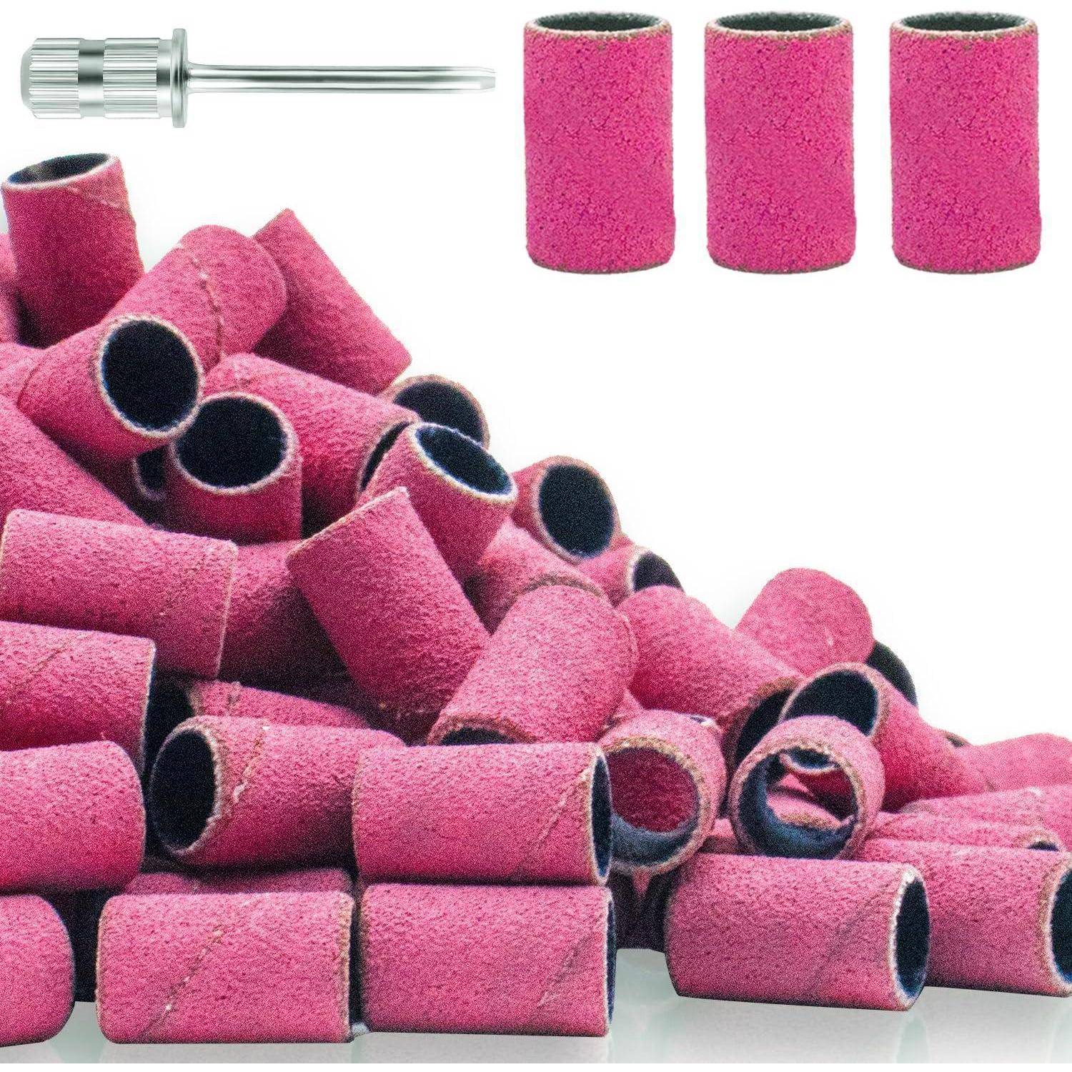 Ein Haufen rosa zylindrischer Schleifhülsen mit drei einzelnen Hülsen und einer Metallspindel zur Befestigung.