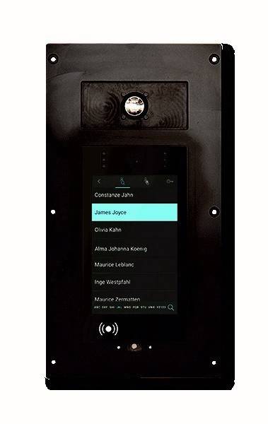 Nahaufnahme eines Türsprechanlagen-Panels mit einer Liste von Namen, die auf einem Bildschirm angezeigt werden, wobei der Name 