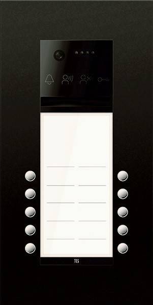 Ein schwarzes Gegensprechanlage-Panel mit einem Lautsprecher am oberen Rand, einem weißen Namensschild-Bereich und jeweils sechs runden Tasten auf beiden Seiten für den Zutritt zu Wohnungen.