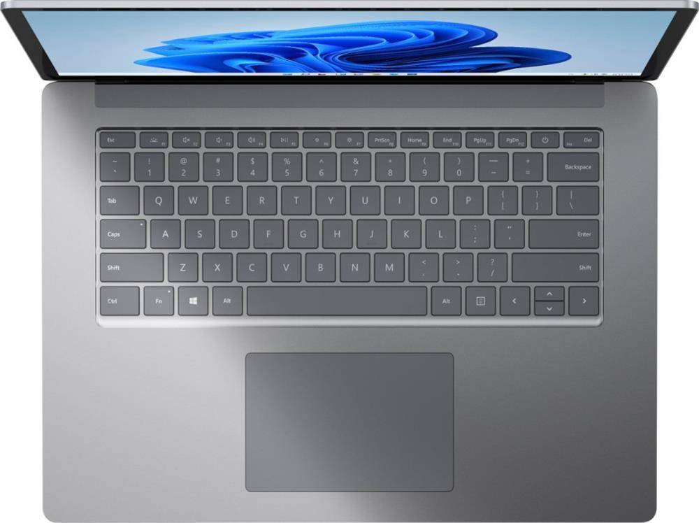 Eine Laptop-Tastatur mit einem Touchpad darunter. Der Bildschirm zeigt einen blauen abstrakten Hintergrund. Die Tastatur enthält standardmäßige Funktionstasten und einen Ziffernblock.