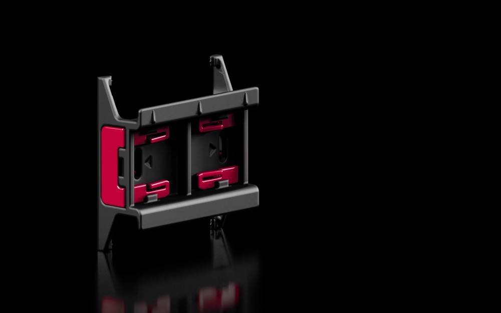 Ein rot-schwarzer Dual-SIM-Kartenhalter, der entwickelt wurde, um zwei SIM-Karten sicher zu halten, mit sichtbaren Schlitzen für einfaches Einsetzen und Herausnehmen.