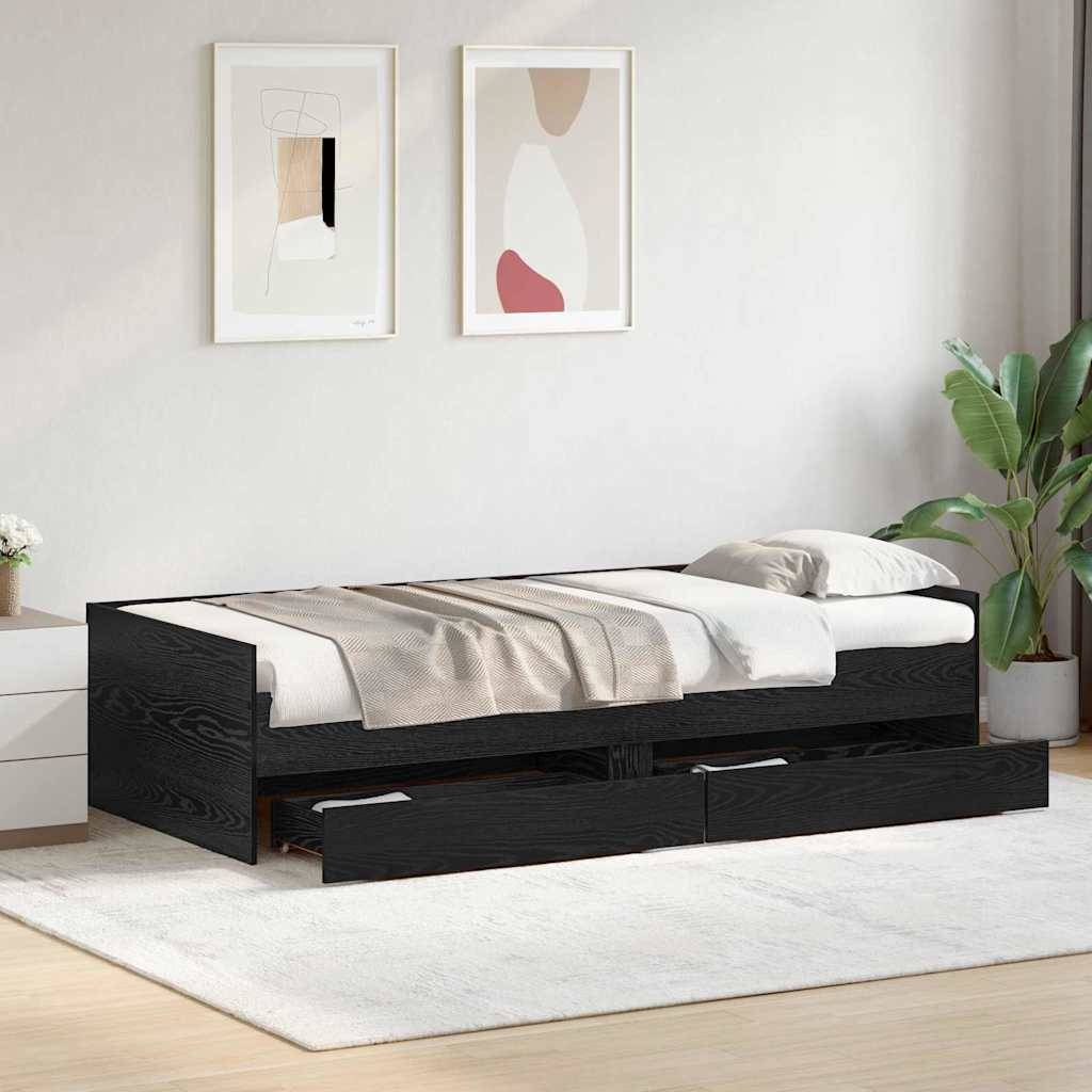 Ein modernes Schlafzimmer mit einem schwarzen Ausziehbett, weißer Bettwäsche, zwei abstrakten Kunstwerken an der Wand und einer großen, blattreichen Pflanze.