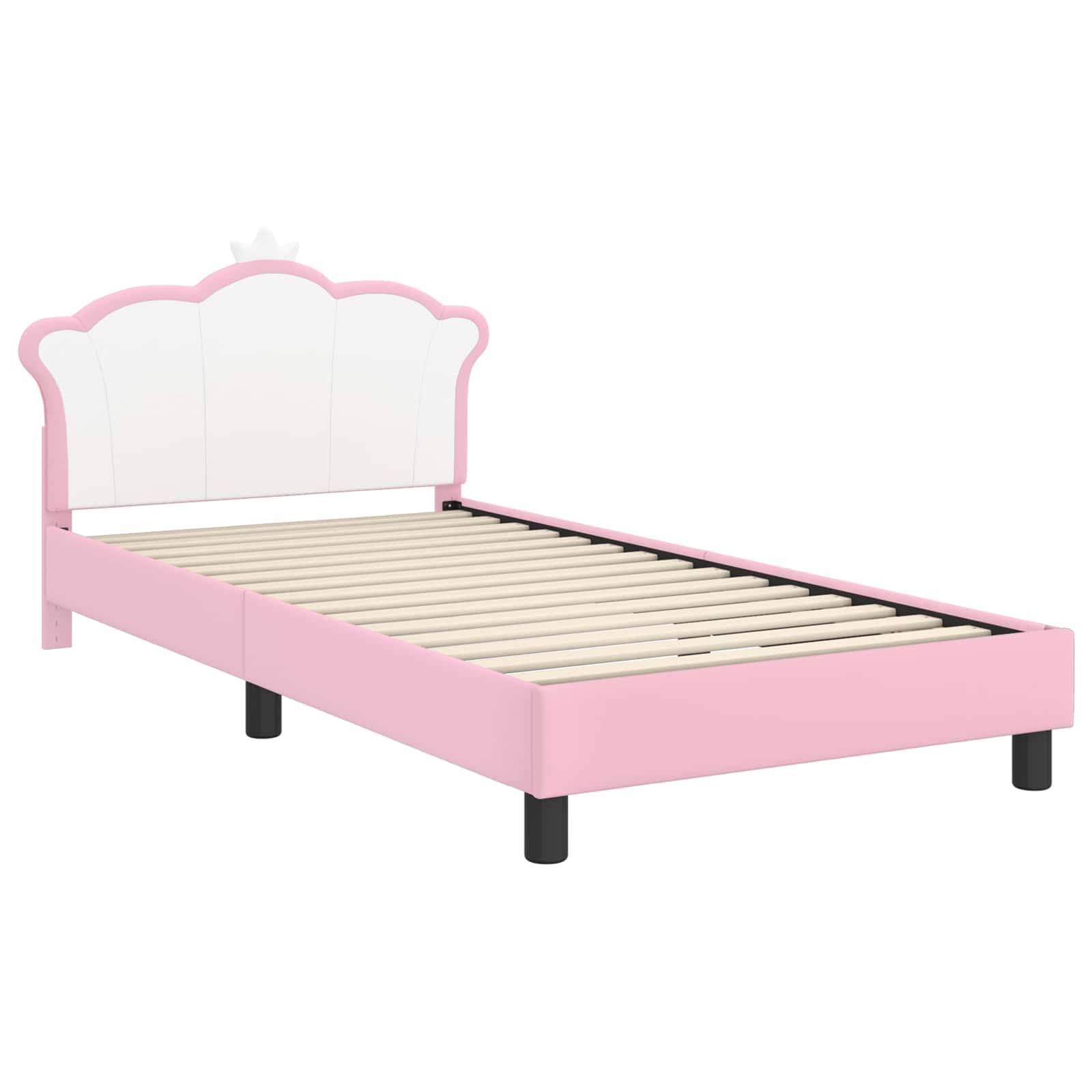 Pinker und weißer Kinderbettrahmen mit einer Krone als Kopfteil und Holzlatten, auf schwarzen Beinen stehend.