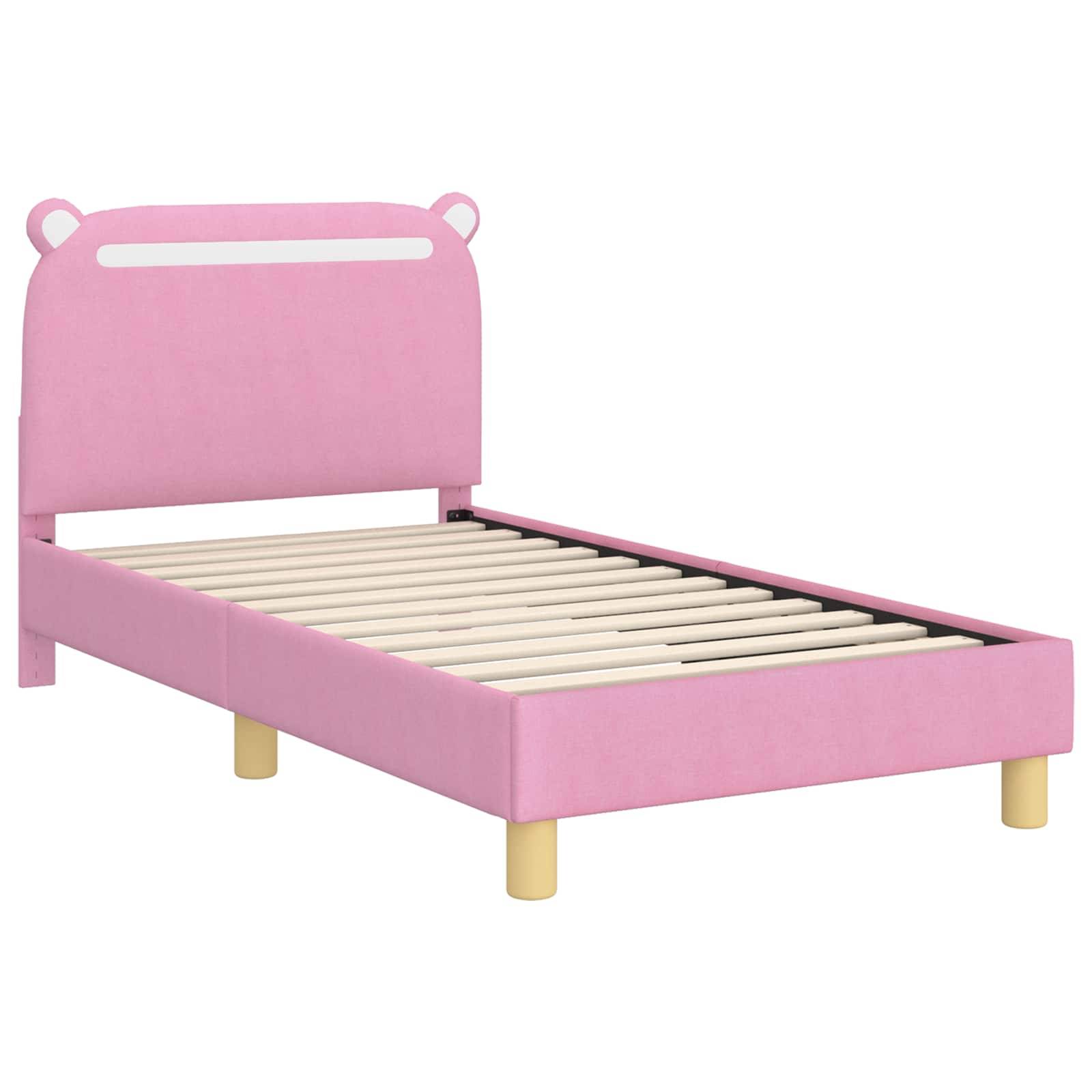 Ein rosa Kinderbettgestell mit einem Kopfteil, das Bärenohren-Designs aufweist, und Holzbeinen. Das Bett wird ohne Matratze gezeigt.