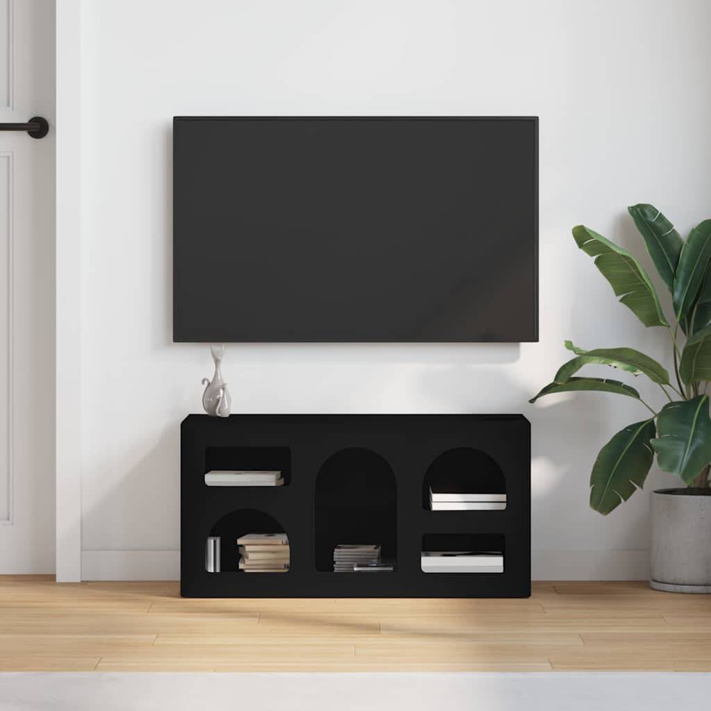 Ein minimalistisches Wohnzimmer-Setup mit einem an der Wand montierten Flachbild-Fernseher über einer schwarzen Konsole mit Büchern, neben einer Topfpflanze.