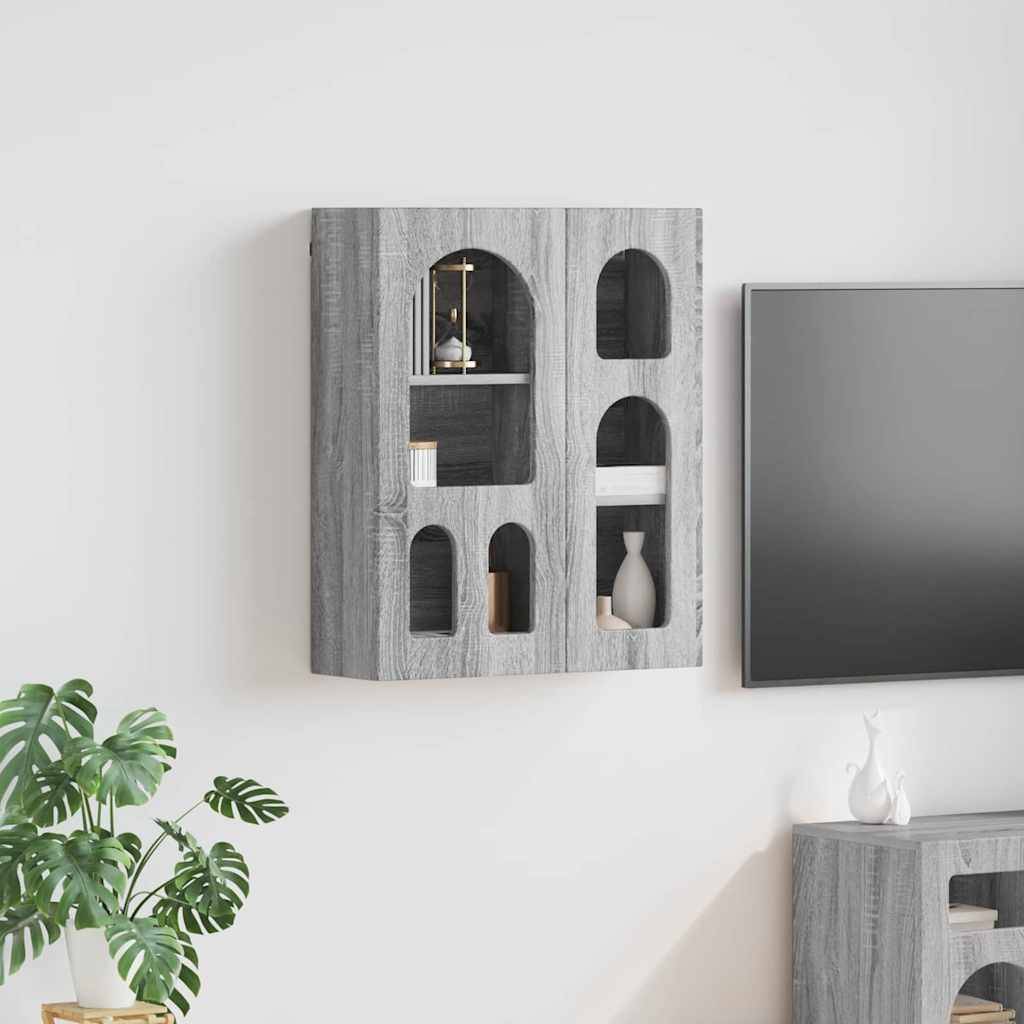 Ein moderner Wohnraum mit einem grauen, wandmontiertem Schrank mit offenen Regalen und einem Fernseher. Eine Pflanze und eine Vase befinden sich in der Nähe auf einem Sideboard.