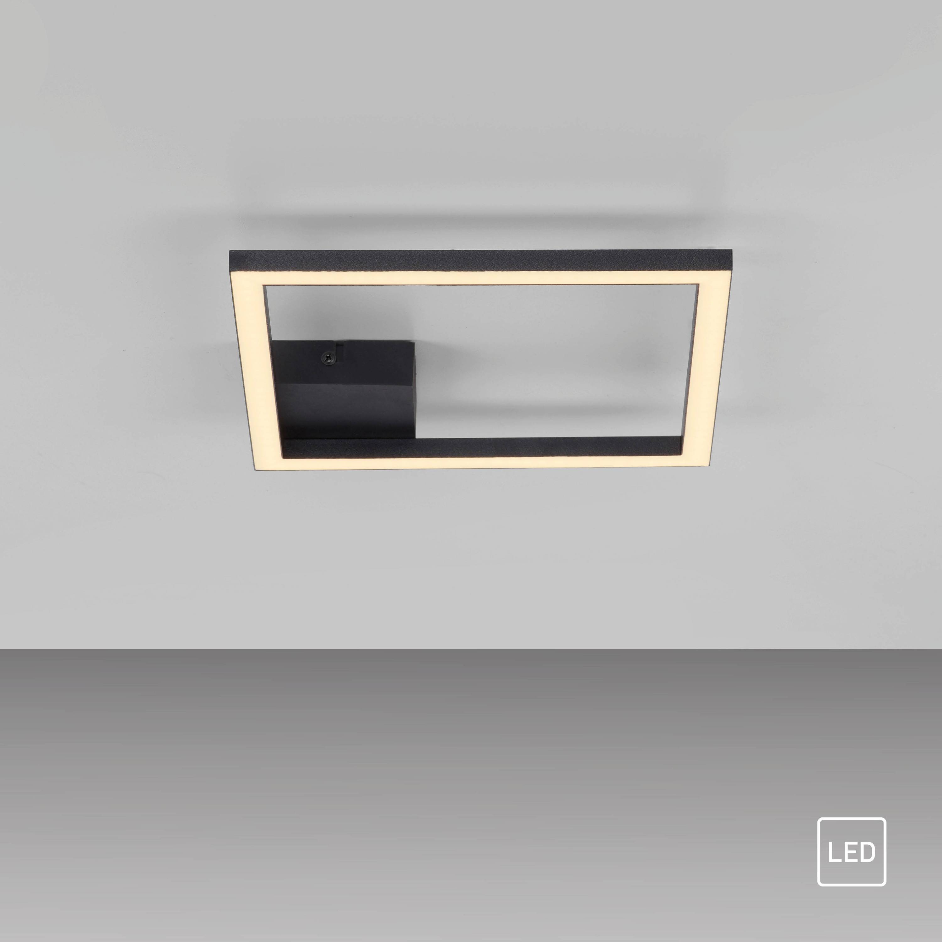 Eine moderne rechteckige LED-Leuchte, die an einer grauen Wand montiert ist und ein weiches Glühen ausstrahlt. Ein kleines 'LED'-Etikett ist in der unteren Ecke sichtbar.