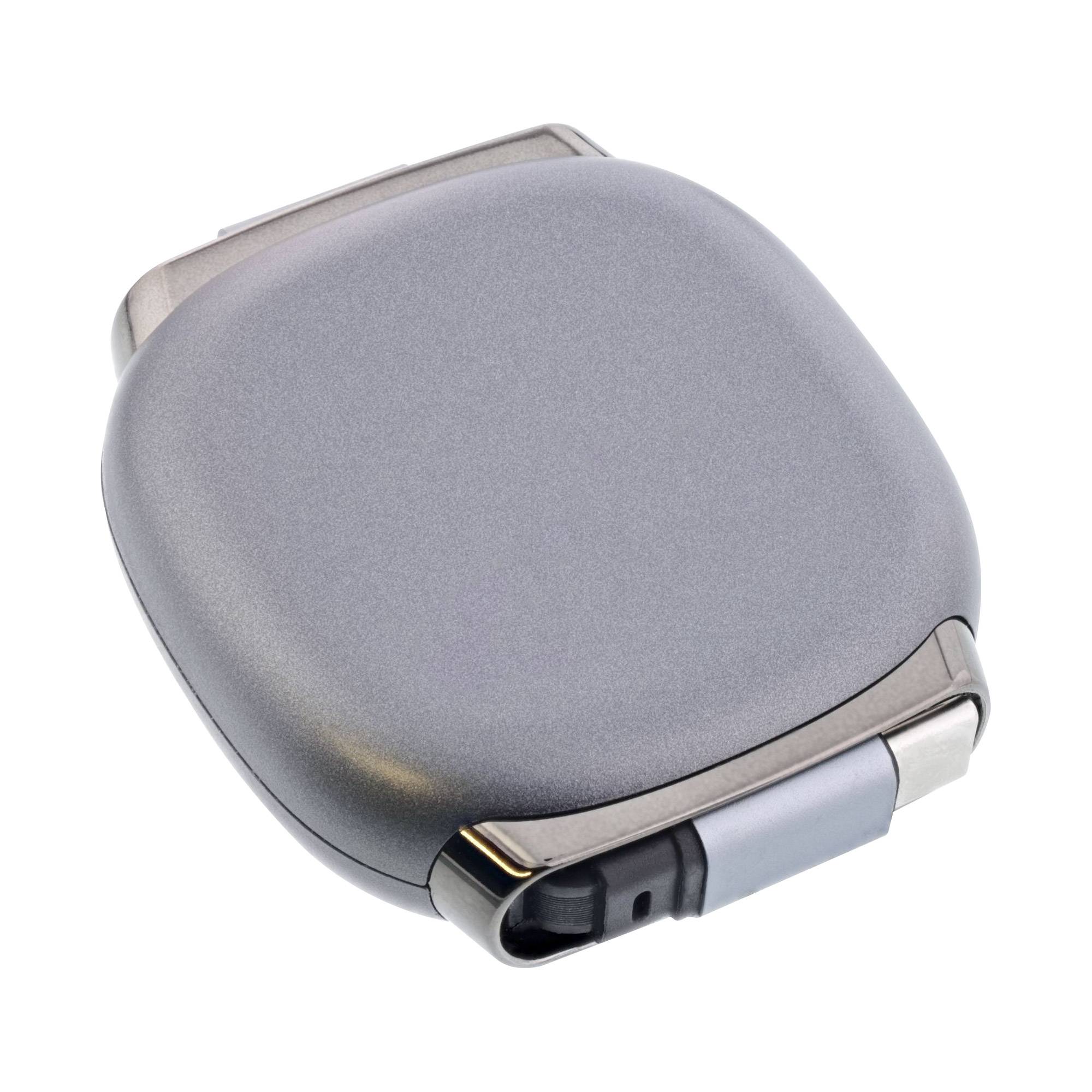 Ein grauer, quadratischer elektronischer Apparat mit Metalloberfläche, der auf einer Seite einen dunklen Knopf aufweist. Er erinnert an ein kompaktes Ladegerät oder ein Hightech-Gerät.