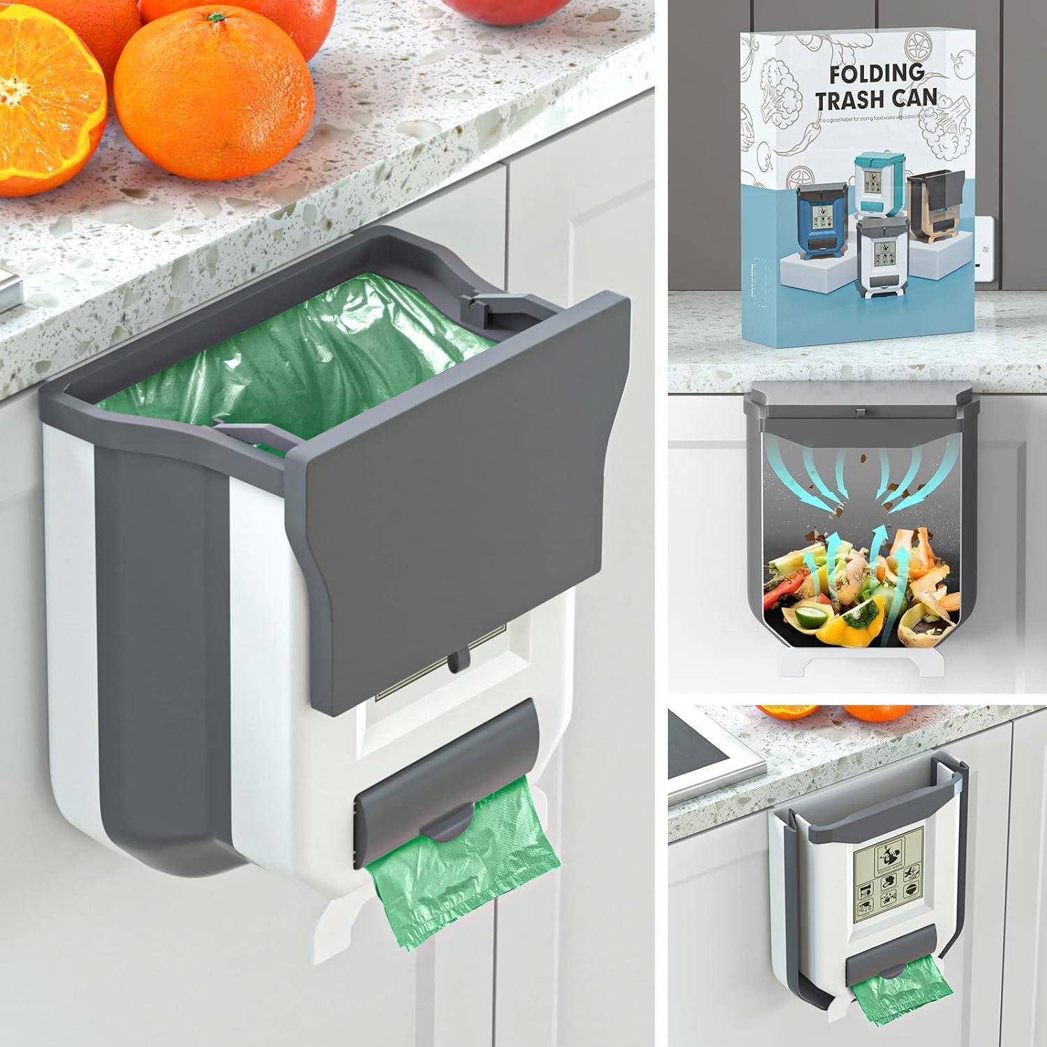 Klappbarer Mülleimer auf der Küchenarbeitsplatte, geöffnet mit grünem Müllbeutel, der Lebensmittelabfälle enthält. Verpackungskarton und Orangen sind auf der Arbeitsplatte sichtbar.