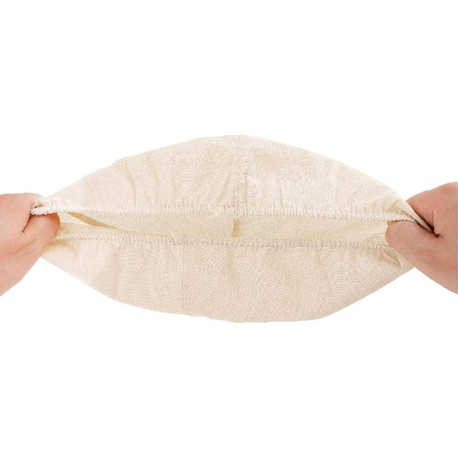 Hände, die einen cremefarbenen, dehnbaren Kissenbezug halten und dessen Elastizität demonstrieren.