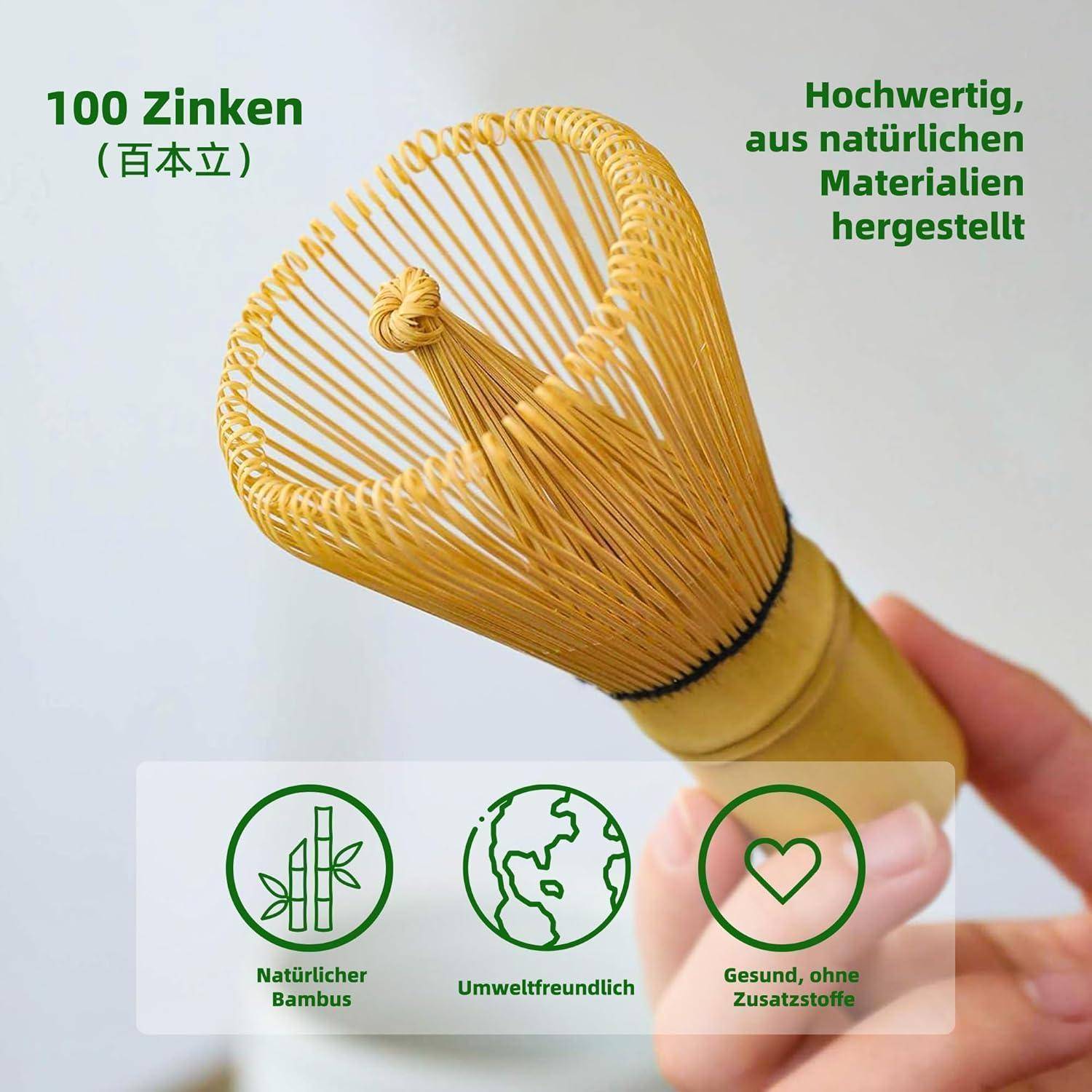 Ein Bambus-Schneebesen mit '100 Zinken' in deutscher Beschriftung, was '100 Zinken' bedeutet. Icons darunter zeigen, dass er natürlich, umweltfreundlich und additiv-frei ist.