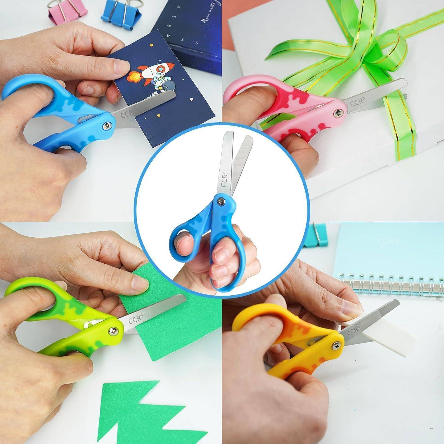 Kinder benutzen bunte Sicherheitsscheren, um Papier und grünes Band zu schneiden. Die Scheren verfügen über einen Kunststoffgriff für einfache Handhabung und Sicherheit.