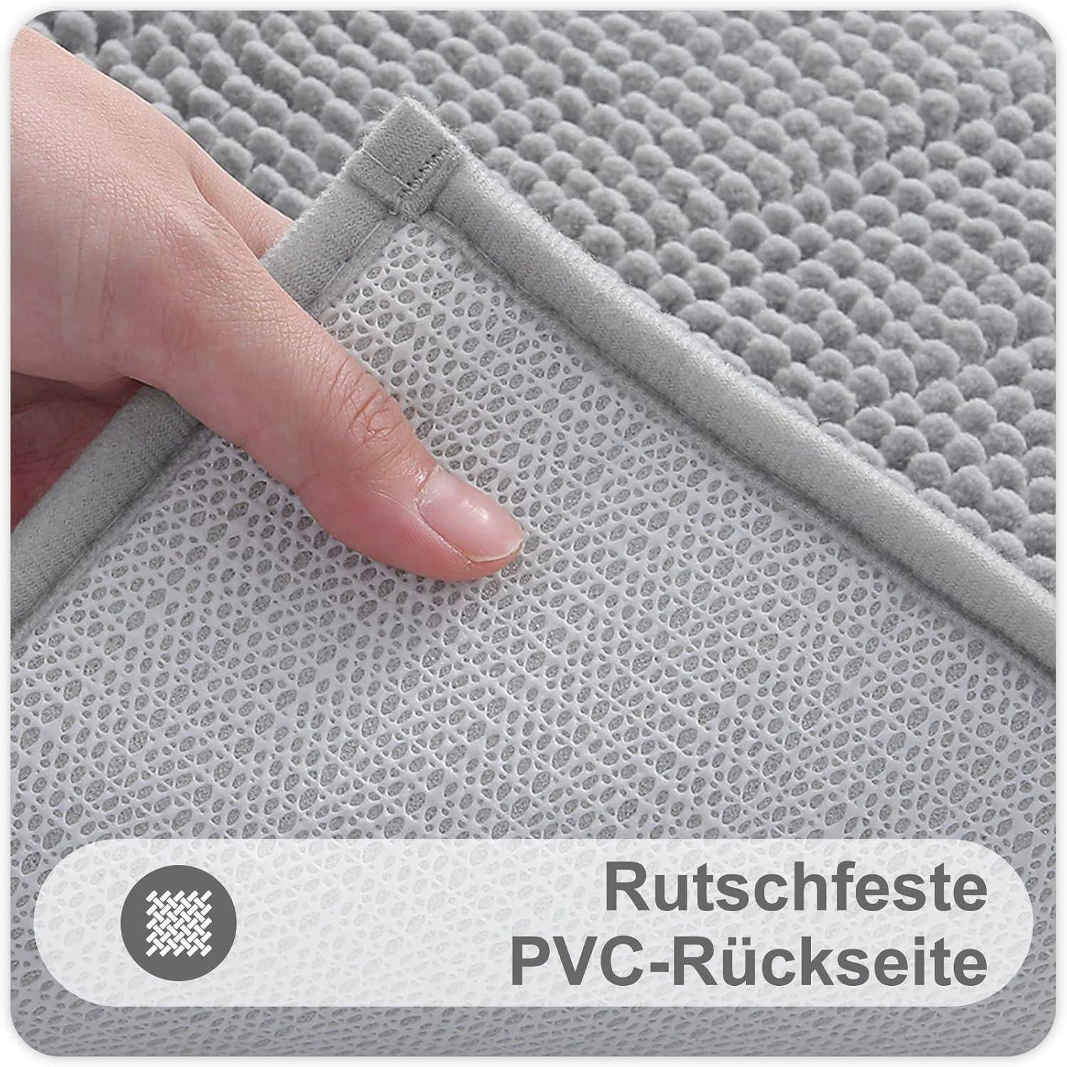 Eine Hand hebt die Ecke eines grauen strukturierten Teppichs und zeigt die rutschfeste PVC-Rückseite. Deutscher Text lautet: 