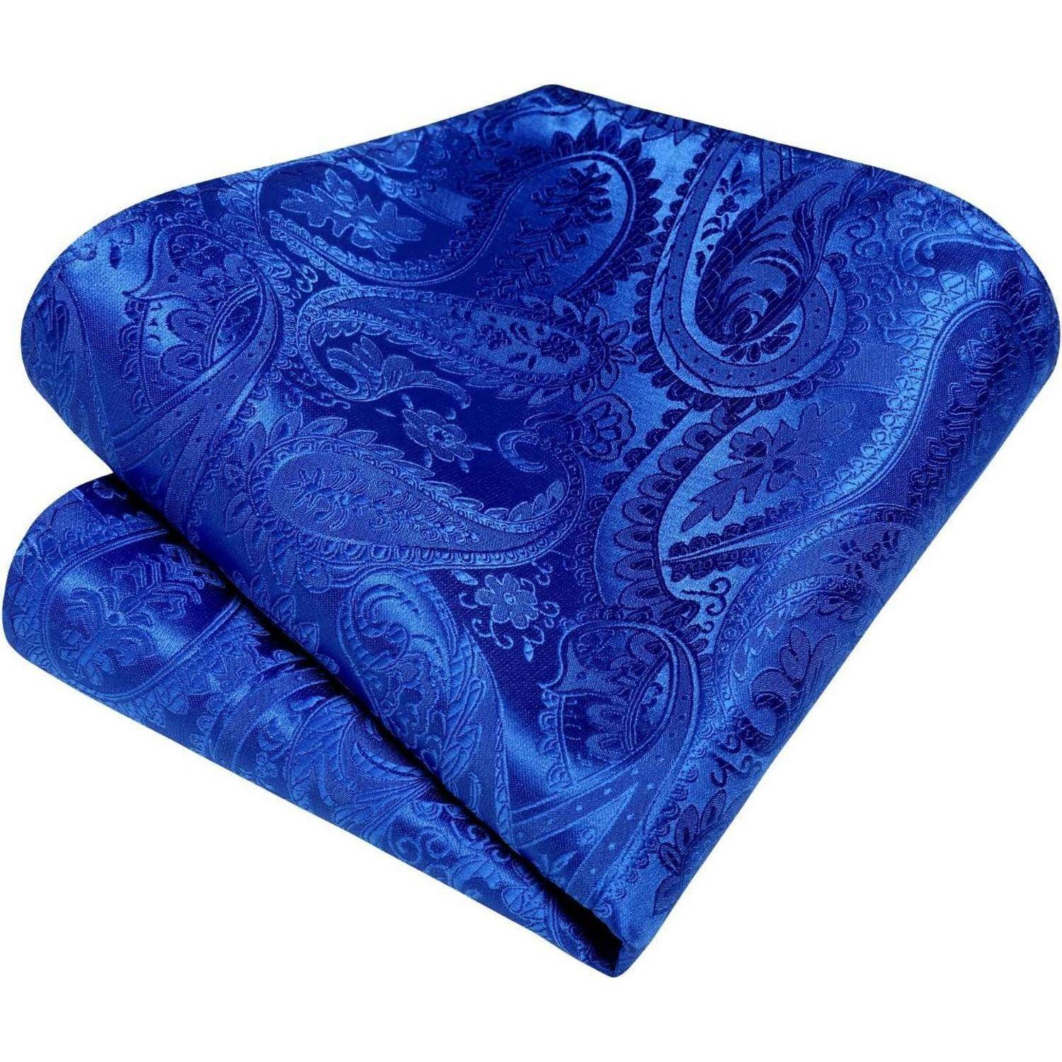 Ein gefaltetes, königsblau gemustertes Paisley-Tuch ist sorgfältig ausgebreitet und zeigt ausladende, verschlungene Muster und florale Elemente.