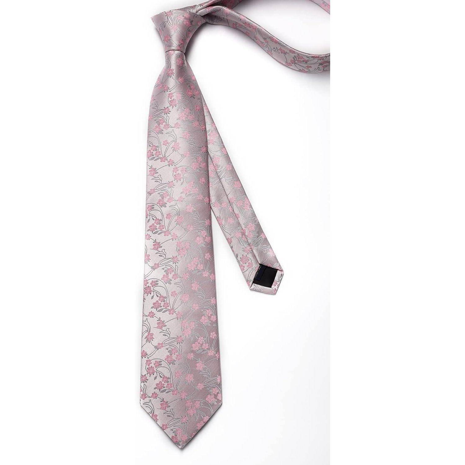 Eine rosa Krawatte mit Blumenmuster auf weißem Hintergrund, die ihr Design und ihre Farbe zur Geltung bringt.