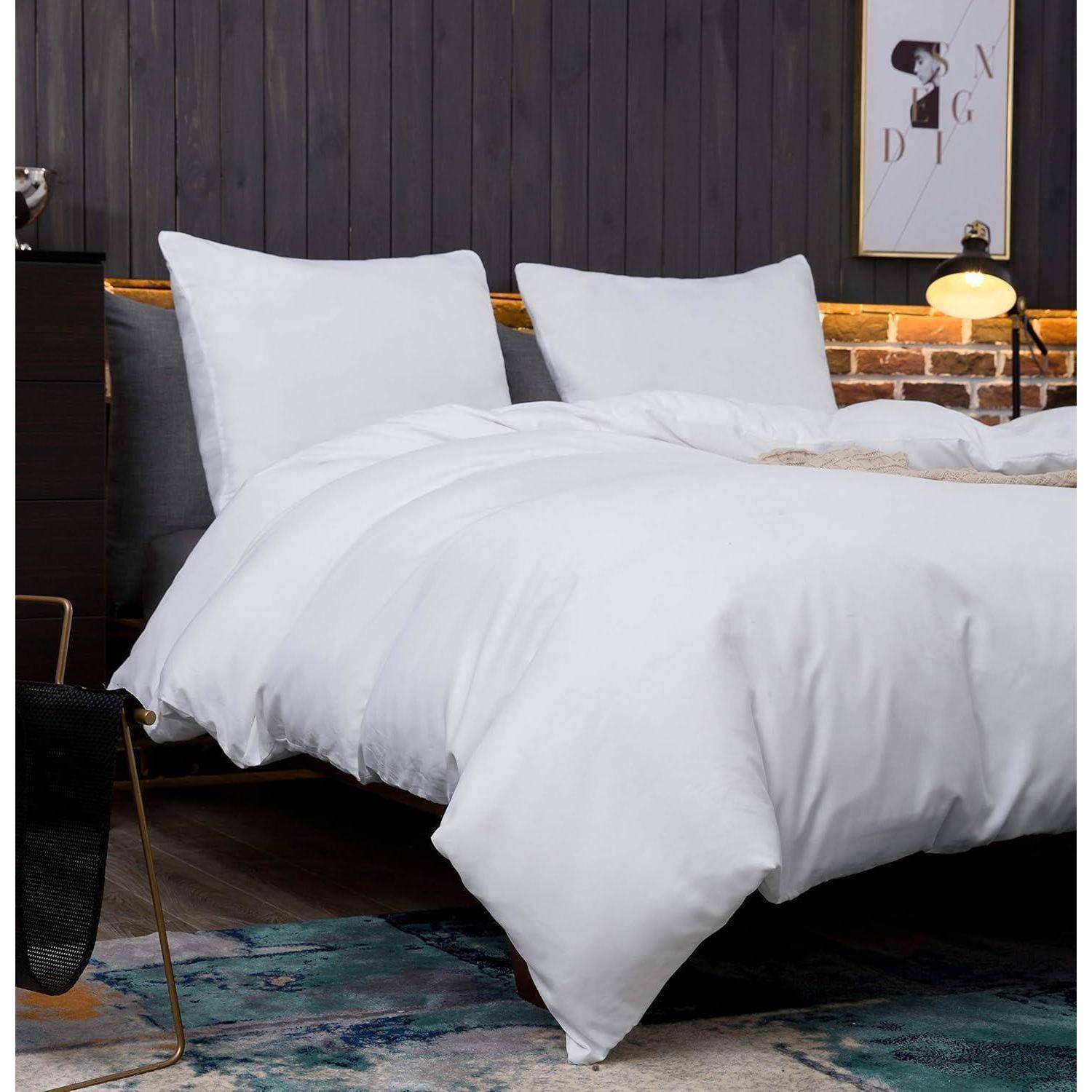 Ein ordentlich gemachtes Bett mit weißer Bettwäsche und Kissen steht in einem stilvollen Raum mit einer Holzvertäfelung an der Wand, moderner Beleuchtung und einem Teppich.