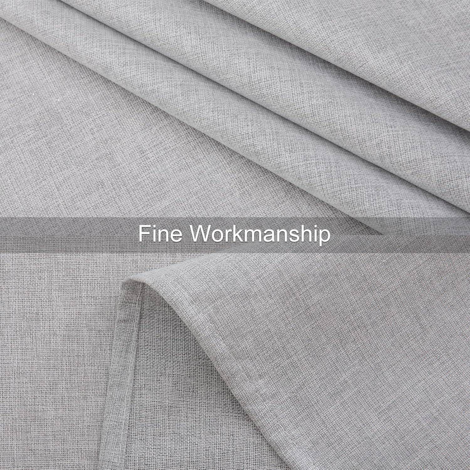 Nahaufnahme von grauem Stoff mit dem Text ‚Feine Handwerkskunst', der auf hochwertige Verarbeitung oder Material hindeutet.