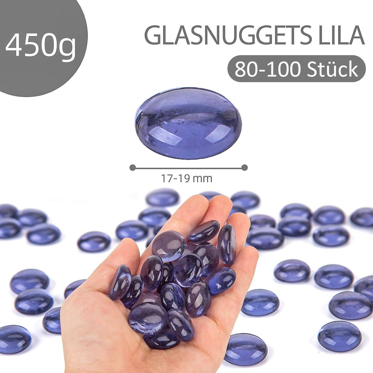 Eine Hand hält mehrere lila Glasnuggets. Text liest sich 'GLASNUGGETS LILA' und '450g', Details zur Größe sind '17-19 mm' mit '80-100 Stück'.