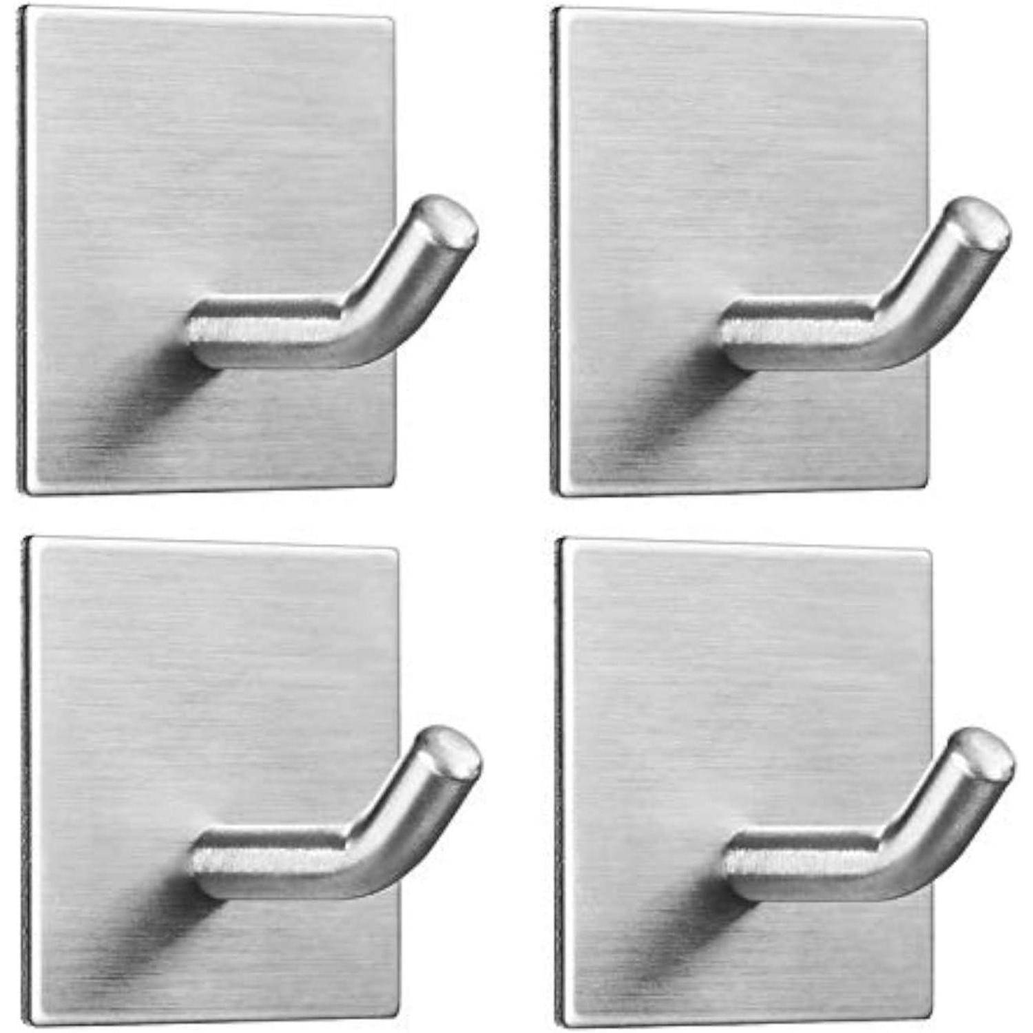 Vier Haken aus Edelstahl mit Klebefunktion auf einem schlichten Hintergrund, in einem quadratischen Raster angeordnet. Jeder Haken ist gebogen und hat eine rechteckige Grundfläche.