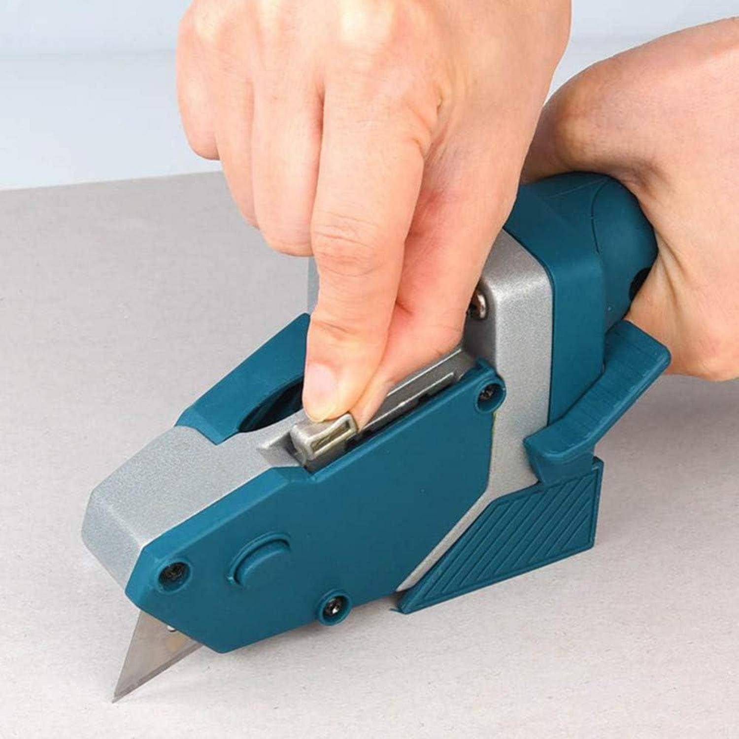 Eine Person, die ein blaues und silbernes Universalmesser mit ausfahrbarer Klinge verwendet und demonstriert, wie man Material auf einer flachen Oberfläche schneidet.