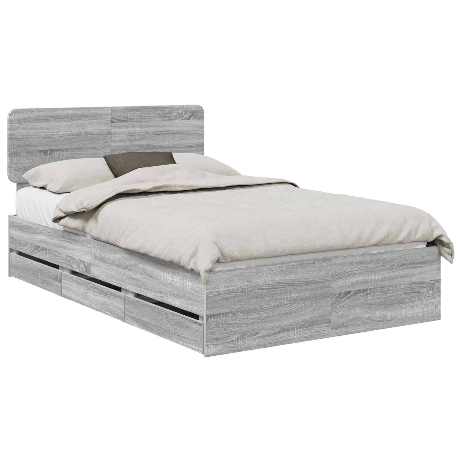 Ein grauer Holzbettrahmen mit Staurageschubladen darunter, ausgestattet mit einer gepolsterten beigen Matratze und Kissen, in minimalistischem Stil.