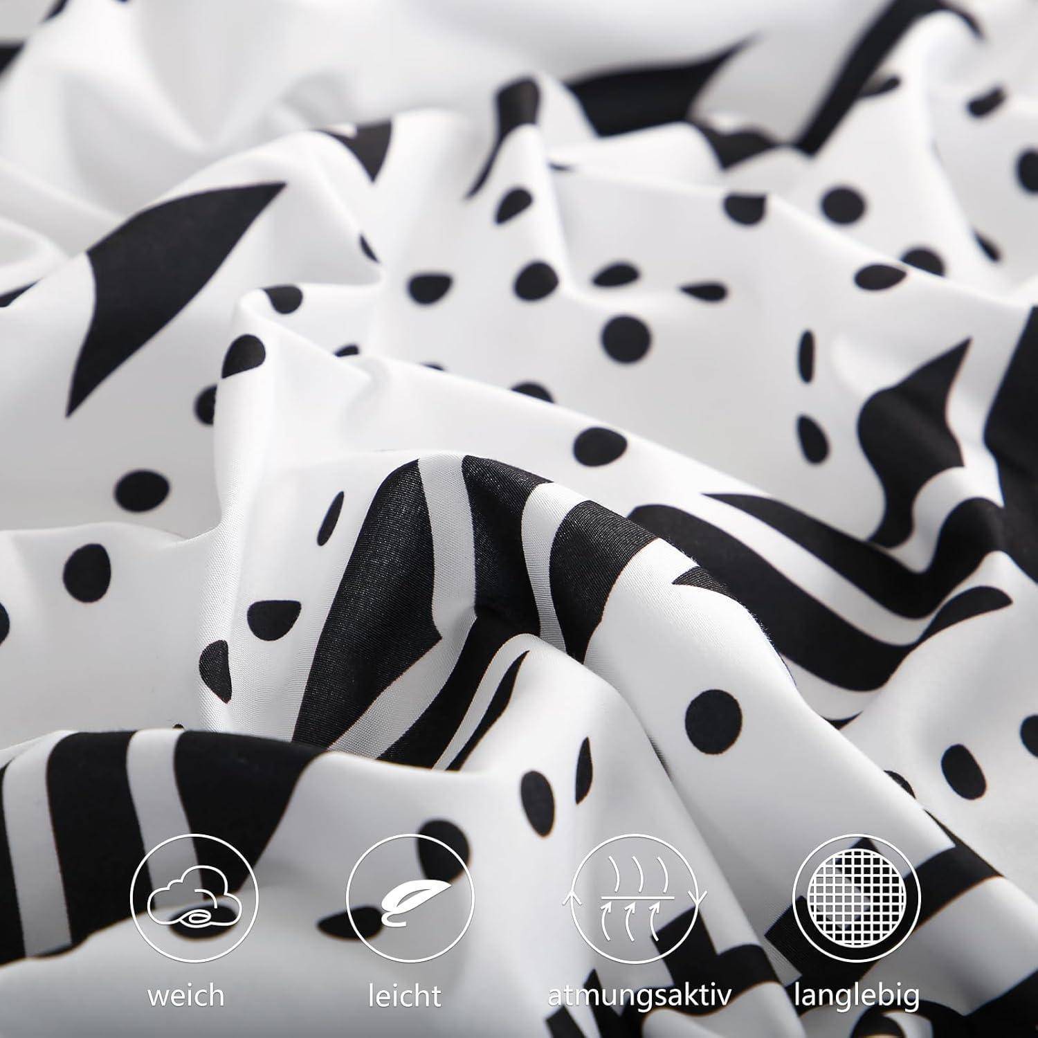 Weißer Stoff mit schwarzen Polka Dots und abstrakten Designs, ausgestattet mit Symbolen und deutschem Text, der anzeigt, dass er ‚weich', ‚leicht', ‚atmungsaktiv' und ‚langlebig' ist.