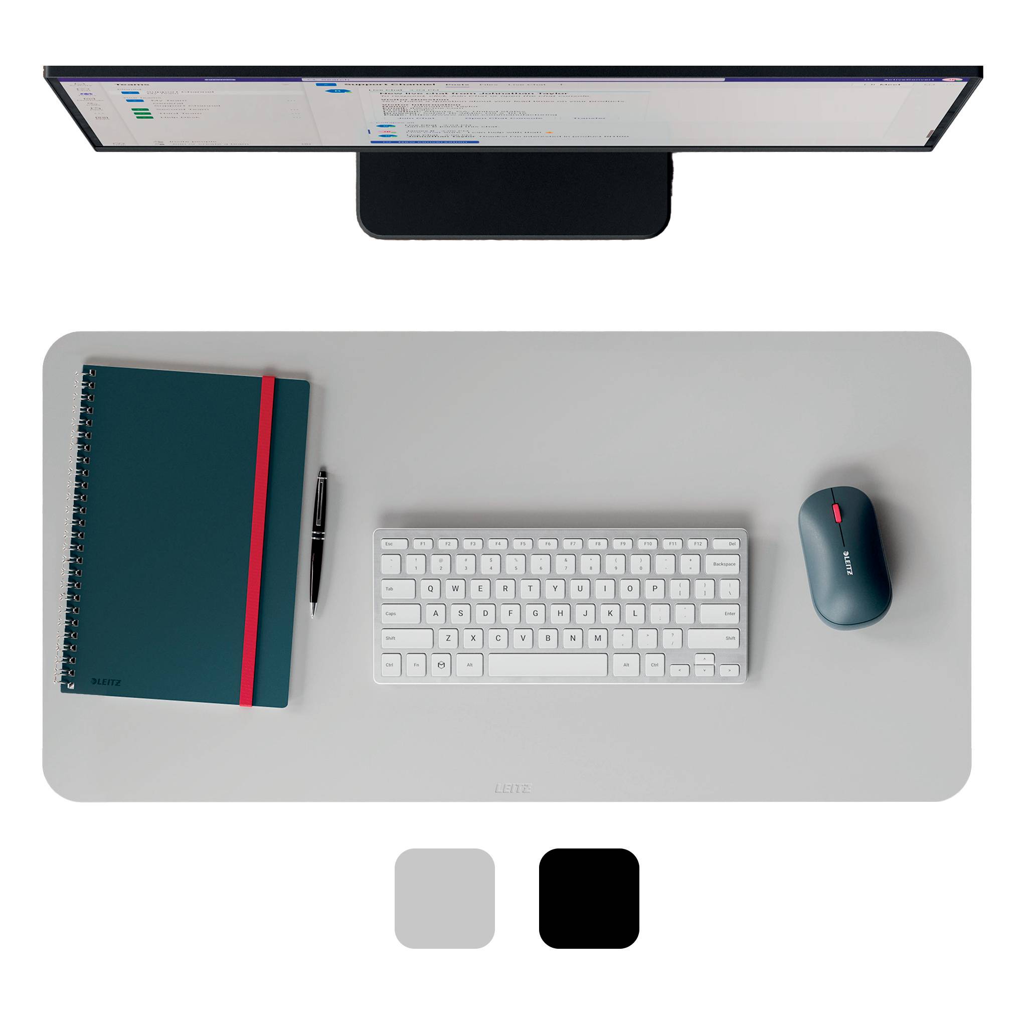 Draufsicht eines minimalistischen Schreibtisch-Setups mit einer Tastatur, Maus, Notizbuch, Stift und einem Monitor an der oberen Kante.