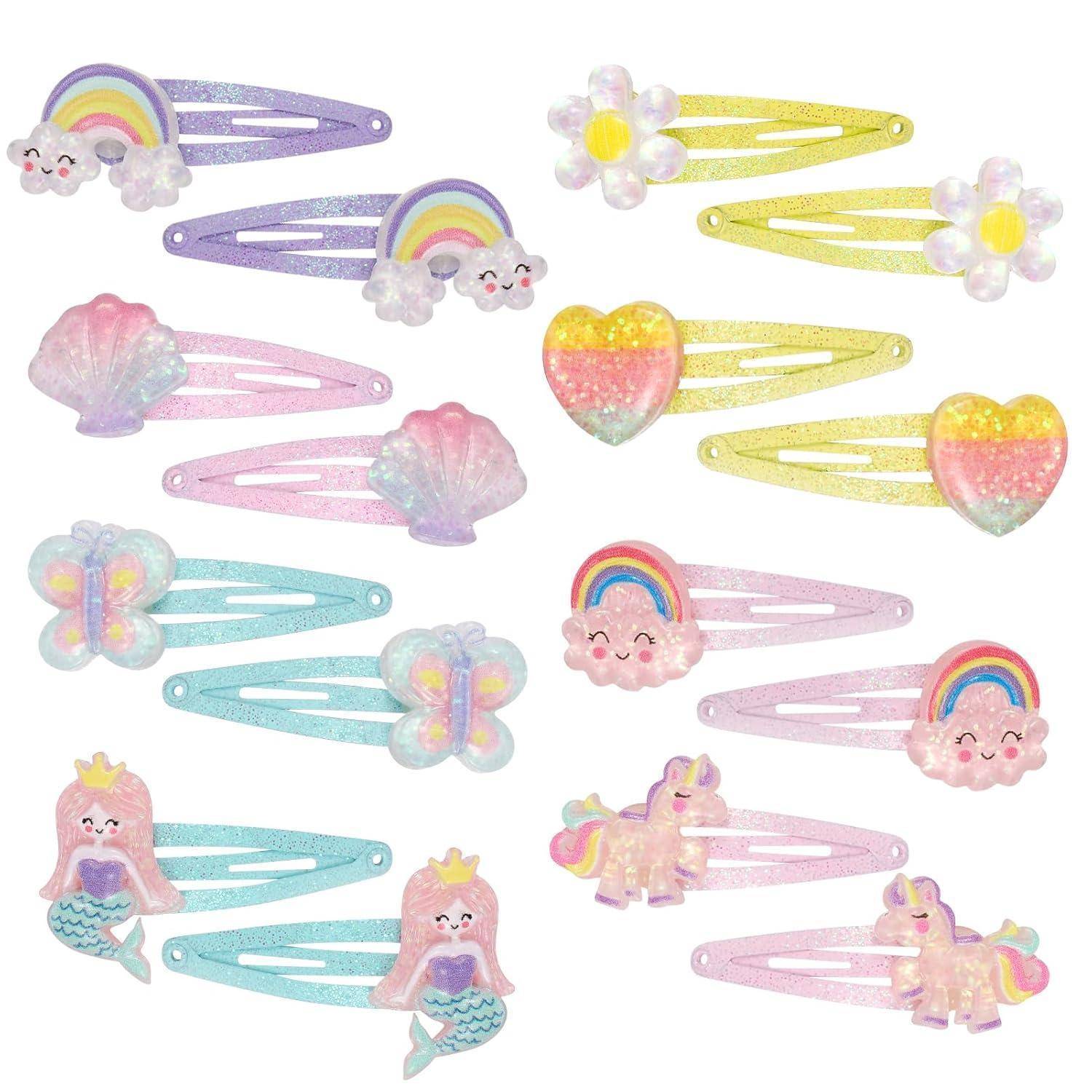 Bunte Haarspangen mit Designs von Regenbögen, Blumen, Muscheln, Herzen, Schmetterlingen, Wolken, Meerjungfrauen und Einhörnern, alle glitzernd.
